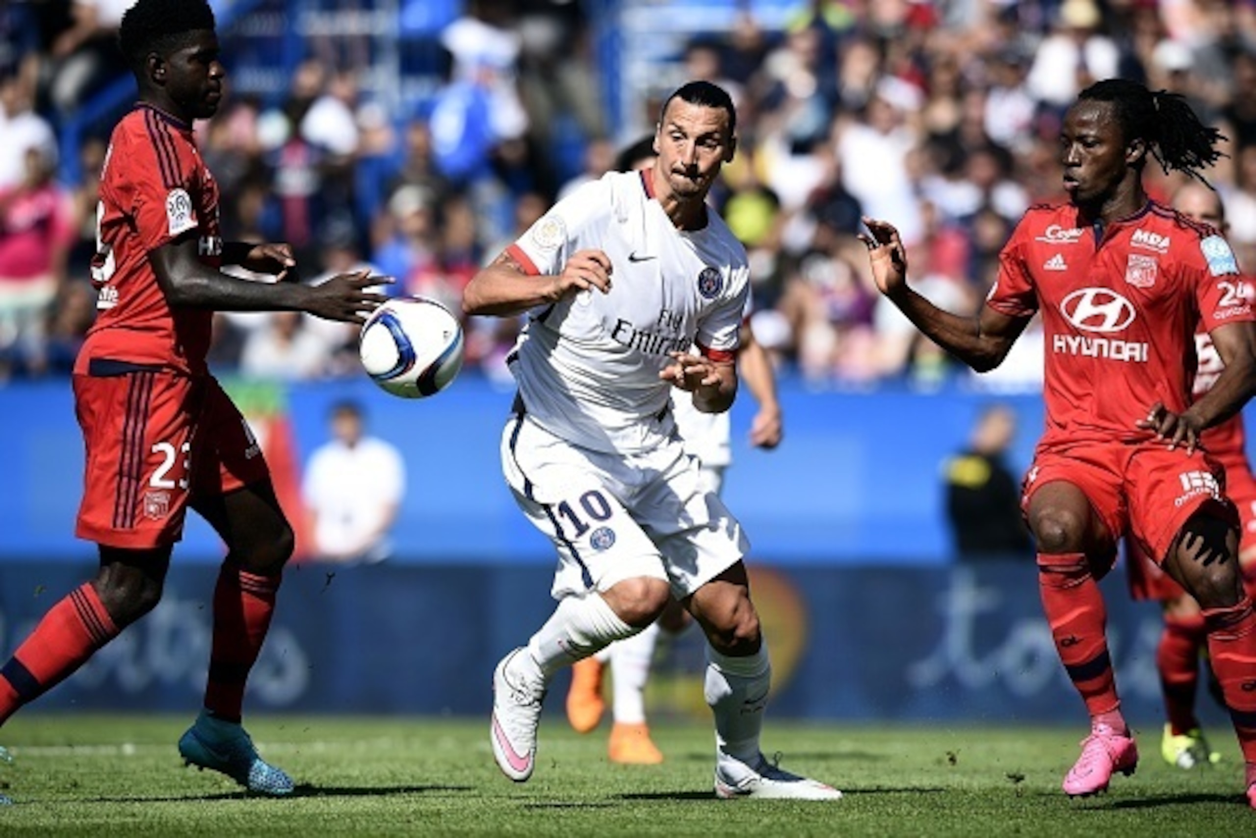Paris Saint-Germain's Swedish forward Zlatan Ibrahimovic (C) vies with Lyon's French Burkinabe defender Bakary Kone (R) and Lyon's French Cameroonian defender Samuel Umtiti during the French Trophy of Champions football match at Saputo stadium in Montreal