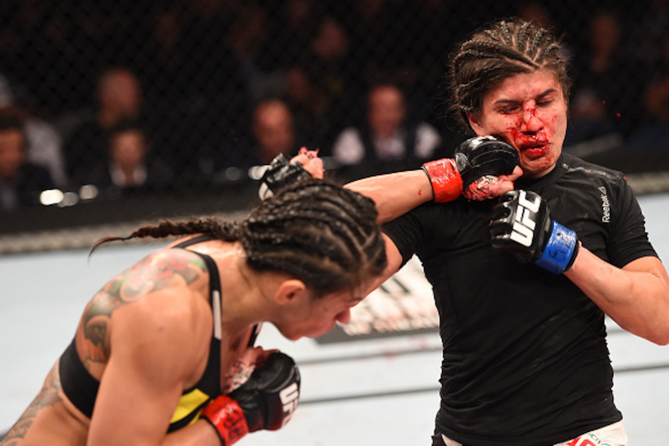 RIO DE JANEIRO, BRAZIL - AUGUST 01:  (L-R) Claudia Gadelha of Brazil punches Jessica Aguilar of the United States in their women's strawweight bout during the UFC 190 event inside HSBC Arena on August 1, 2015 in Rio de Janeiro, Brazil.  (Photo by Josh Hed