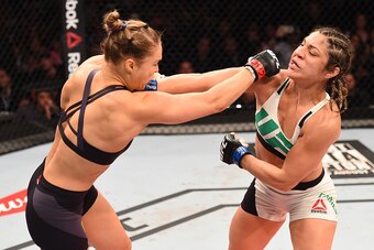 RIO DE JANEIRO, BRAZIL - AUGUST 01:  (L-R) Ronda Rousey of the United States punches Bethe Correia of Brazil in their UFC women's bantamweight championship bout during the UFC 190 event inside HSBC Arena on August 1, 2015 in Rio de Janeiro, Brazil.  (Phot