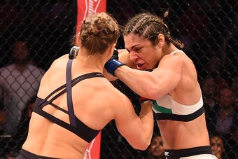 RIO DE JANEIRO, BRAZIL - AUGUST 01:  (L-R) Ronda Rousey of the United States punches Bethe Correia of Brazil in their UFC women's bantamweight championship bout during the UFC 190 event inside HSBC Arena on August 1, 2015 in Rio de Janeiro, Brazil.  (Phot