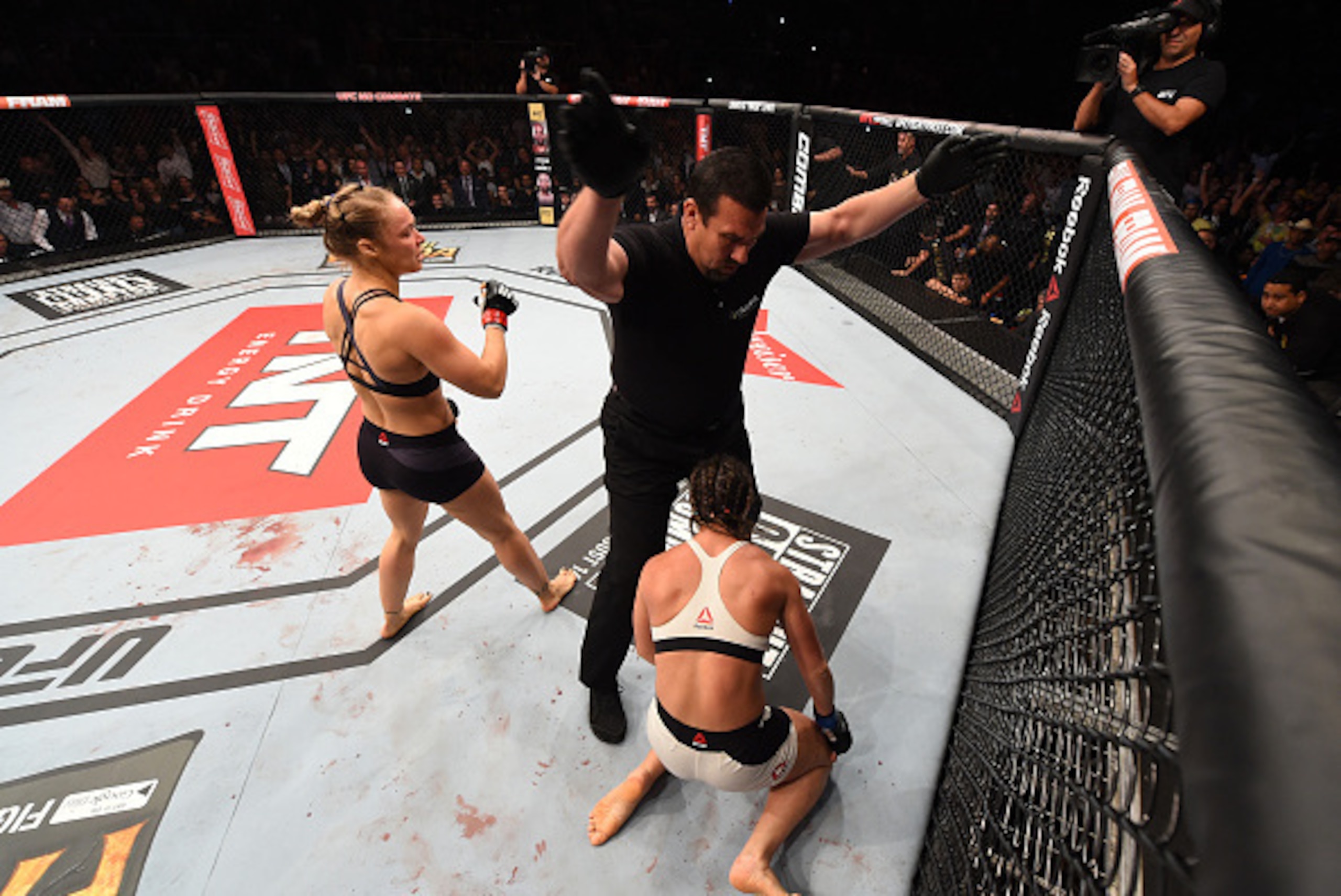 RIO DE JANEIRO, BRAZIL - AUGUST 01:  (L-R) Ronda Rousey of the United States knocks out Bethe Correia of Brazil in the first round in their UFC women's bantamweight championship bout during the UFC 190 event inside HSBC Arena on August 1, 2015 in Rio de J