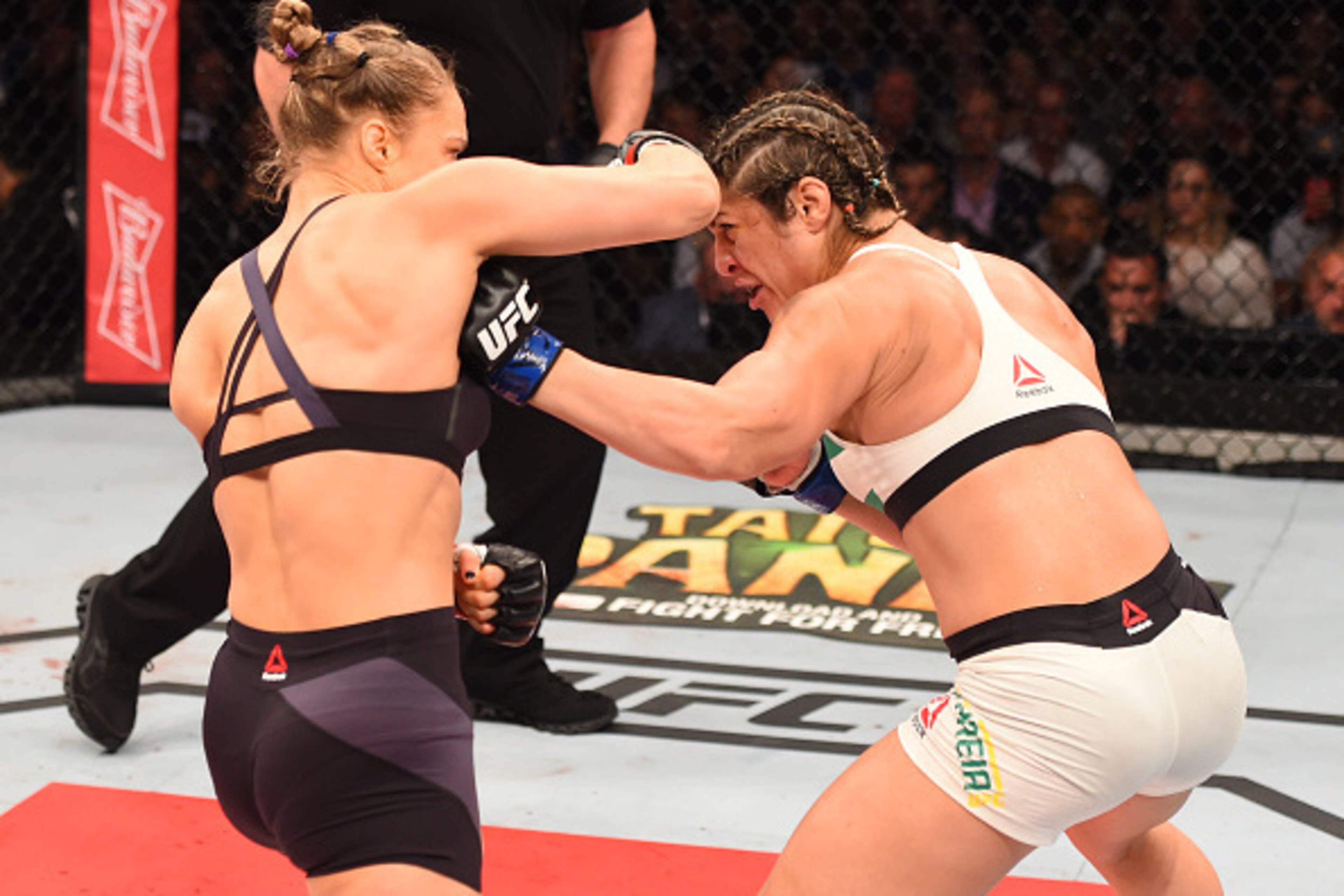 RIO DE JANEIRO, BRAZIL - AUGUST 01:  (L-R) Ronda Rousey of the United States punches Bethe Correia of Brazil in their UFC women's bantamweight championship bout during the UFC 190 event inside HSBC Arena on August 1, 2015 in Rio de Janeiro, Brazil.  (Phot