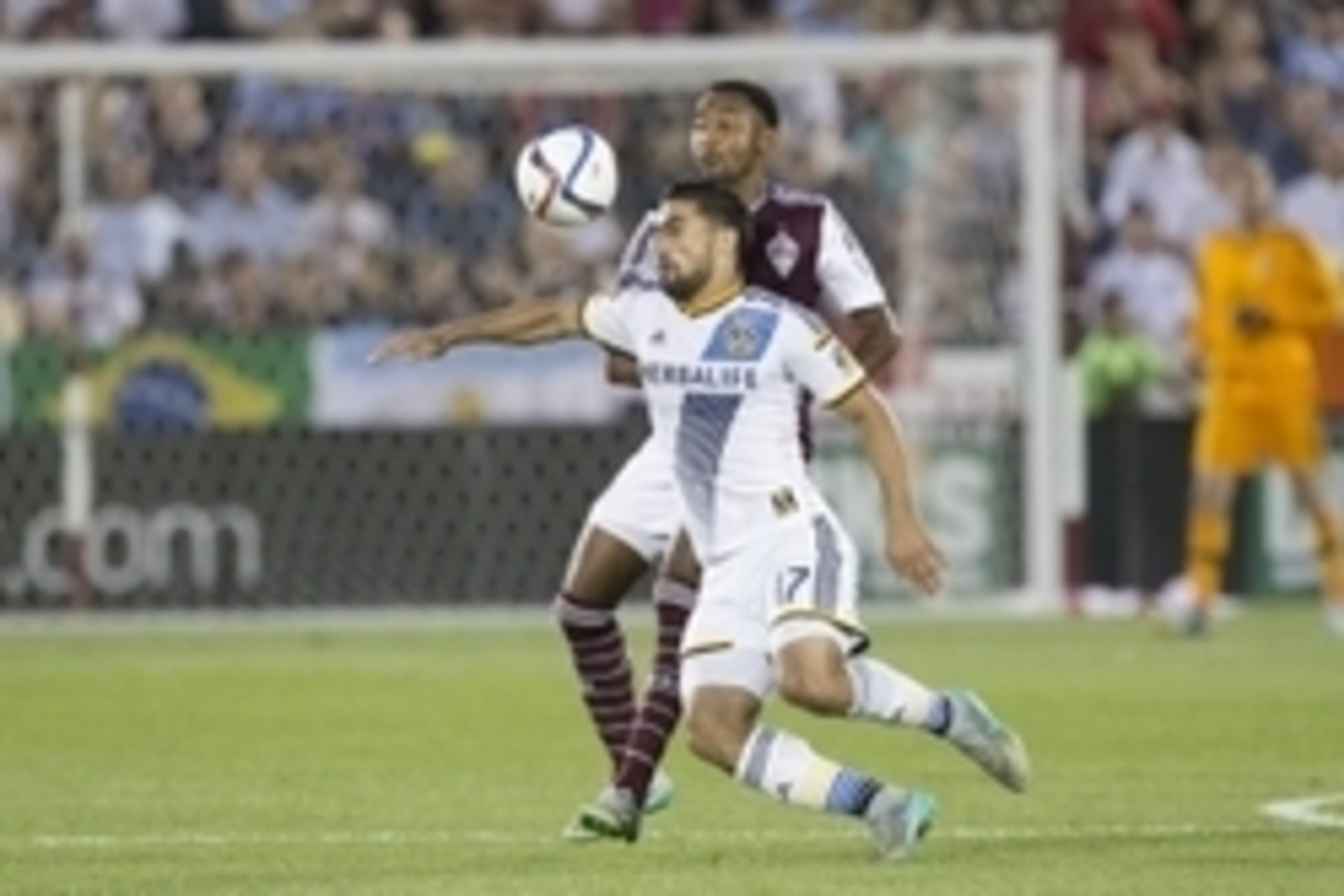 Aug 1, 2015; Commerce City, CO, USA; Los Angeles Galaxy midfielder Sebastian Lletget (17) fields the ball in front of Colorado Rapids defender James Riley (16) in the second half at Dick's Sporting Goods Park. Mandatory Credit: Isaiah J. Downing-USA TODAY