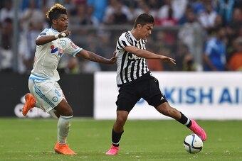 MARSEILLE, FRANCE - AUGUST 01:  Mario Lemina (L) of Olympique de Marseille competes with Paulo Dybala of Juventus FC during the preseason friendly match between Olympique de Marseille and Juventus FC at Stade Velodrome on August 1, 2015 in Marseille, Fran
