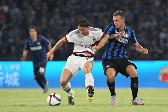 GUANGZHOU, CHINA - JULY 25: Montolivo Riccardo of AC Milan competes the ball with Dimarco Federico of FC Internazionale during the match of International Champions Cup China 2015 between AC Milan and FC Internazionale at Longgang Sport Center Stadium on J