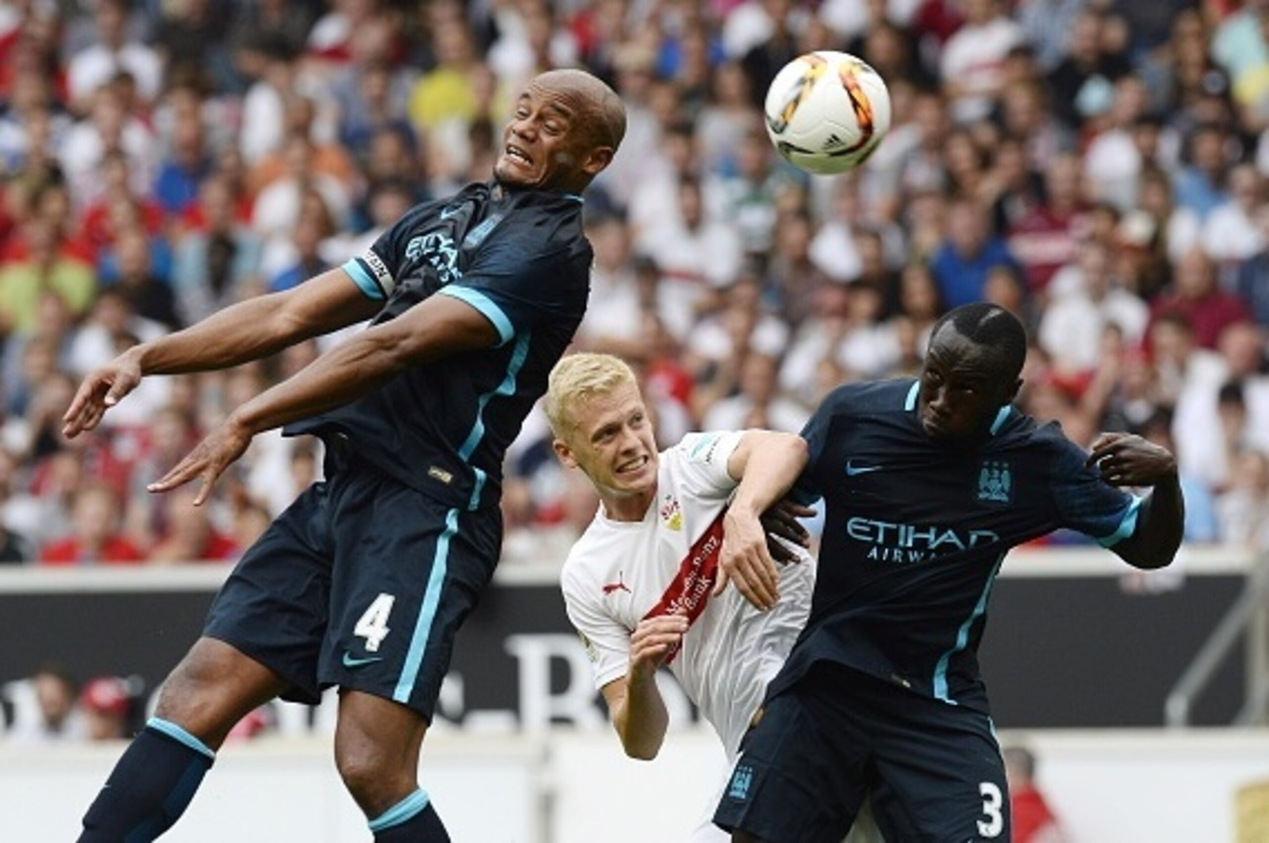 Stuttgart's defender Timo Baumgartl (C) vies for the ball with Manchester's defender Vincent Kompany (L) and Manchester's French defender Bacary Sagna during the friendly football match between VfB Stuttgart and Manchester City in Stuttgart, southern Germ