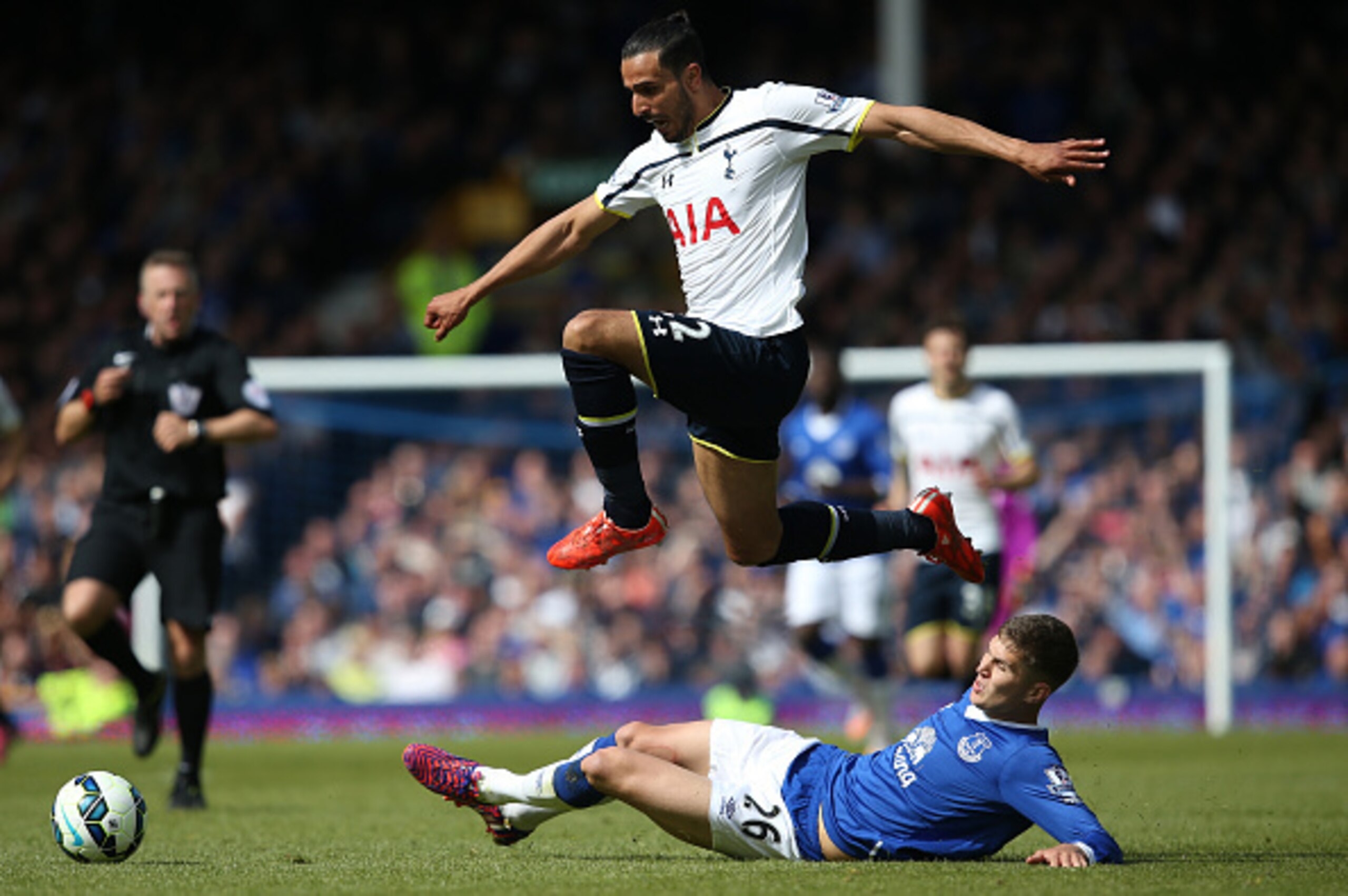 LIVERPOOL, ENGLAND - MAY 24: Nacer Chadli of Spurs and John Stones of Everton compete for the ball during the Barclays Premier League match between Everton and Tottenham Hotspur at Goodison Park on May 24, 2015 in Liverpool, England.  (Photo by Jan Kruger