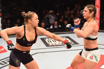 RIO DE JANEIRO, BRAZIL - AUGUST 01:  (L-R) Ronda Rousey of the United States throws a punch at Bethe Correia of Brazil in their UFC women's bantamweight championship bout during the UFC 190 event inside HSBC Arena on August 1, 2015 in Rio de Janeiro, Braz