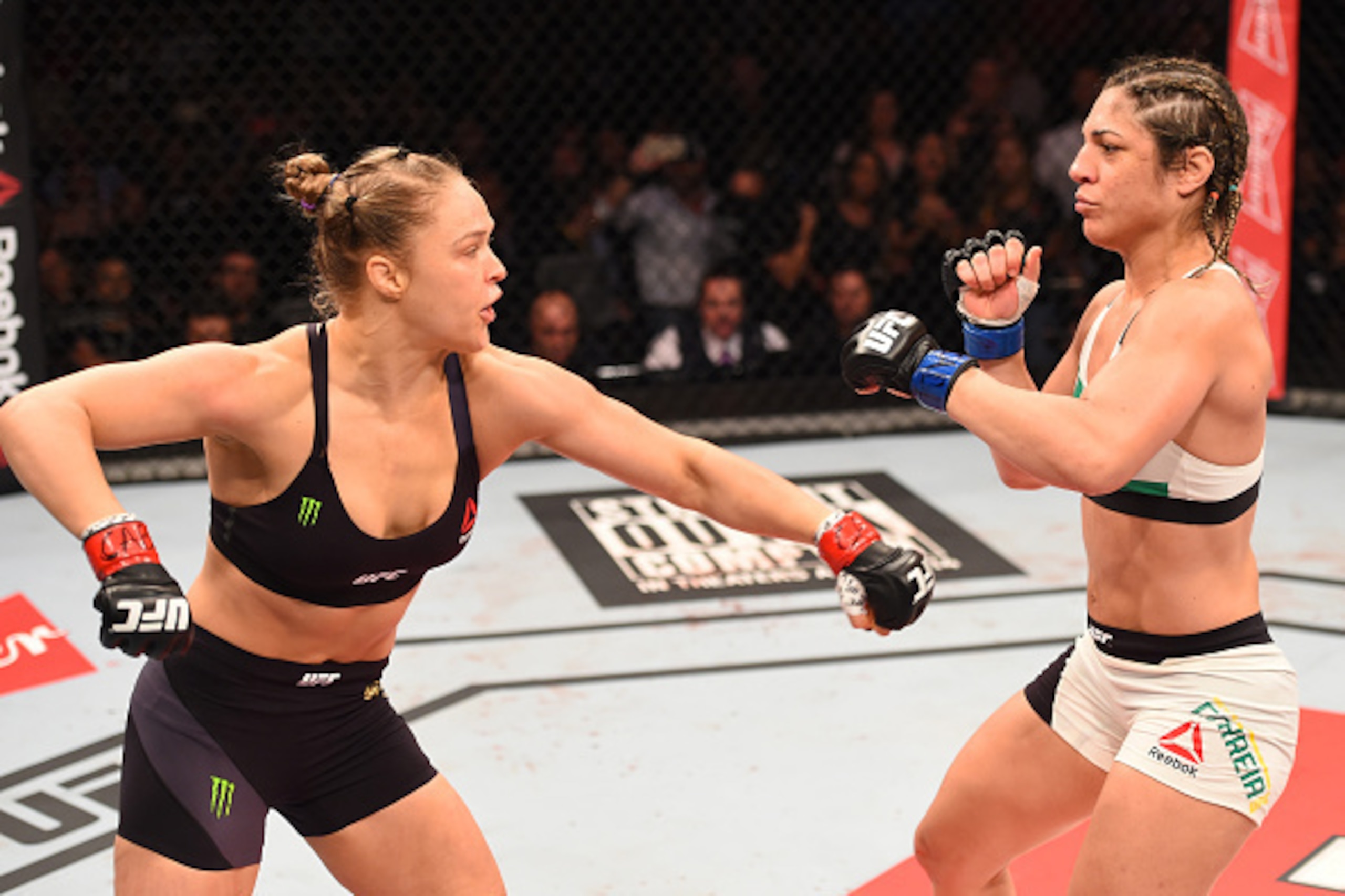 RIO DE JANEIRO, BRAZIL - AUGUST 01:  (L-R) Ronda Rousey of the United States throws a punch at Bethe Correia of Brazil in their UFC women's bantamweight championship bout during the UFC 190 event inside HSBC Arena on August 1, 2015 in Rio de Janeiro, Braz