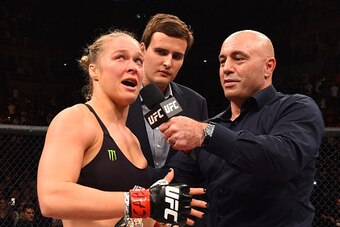 RIO DE JANEIRO, BRAZIL - AUGUST 01:  (L-R) Ronda Rousey of the United States speaks to Joe Rogan after her knock out victory over Bethe Correia of Brazil in the first round in their UFC women's bantamweight championship bout during the UFC 190 event insid