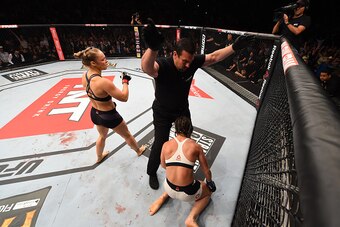 RIO DE JANEIRO, BRAZIL - AUGUST 01:  (L-R) Ronda Rousey of the United States knocks out Bethe Correia of Brazil in the first round in their UFC women's bantamweight championship bout during the UFC 190 event inside HSBC Arena on August 1, 2015 in Rio de J