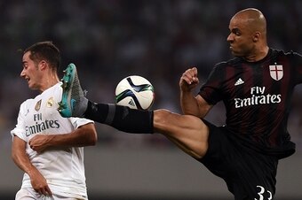 AC Milan's Brazilian defender Rodriego Alex  (R) and Real Madrid's Spainnish midfielder Lucas VÃ¡zquez vie for the ball during the International Champions Cup football match between AC Milan and Real Madrid in Shanghai on July 30, 2015.   AFP PHOTO / JOHA