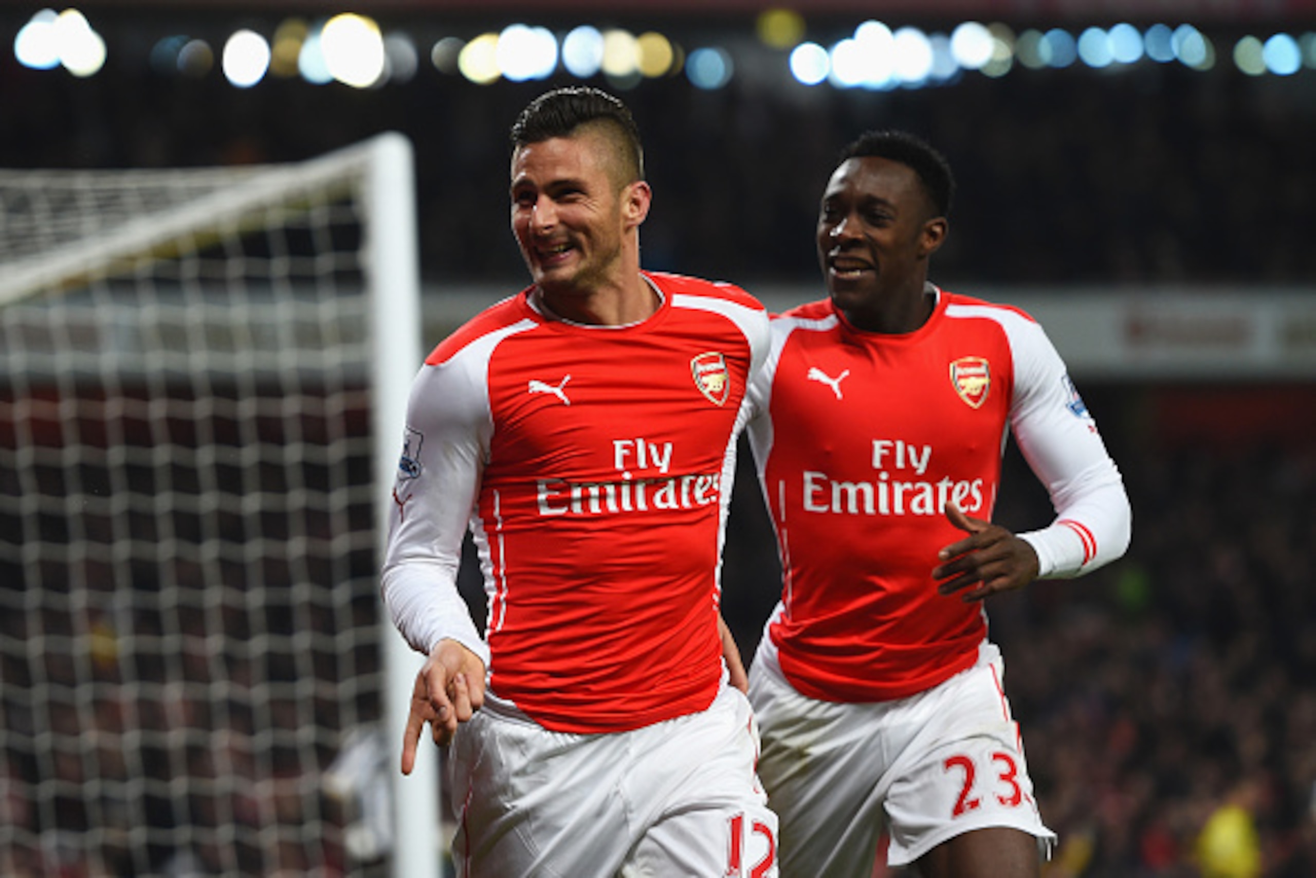 LONDON, ENGLAND - DECEMBER 13:  Olivier Giroud of Arsenal celebrates scoring his team's third goal with Danny Welbeck during the Barclays Premier League match between Arsenal and Newcastle United at Emirates Stadium on December 13, 2014 in London, England