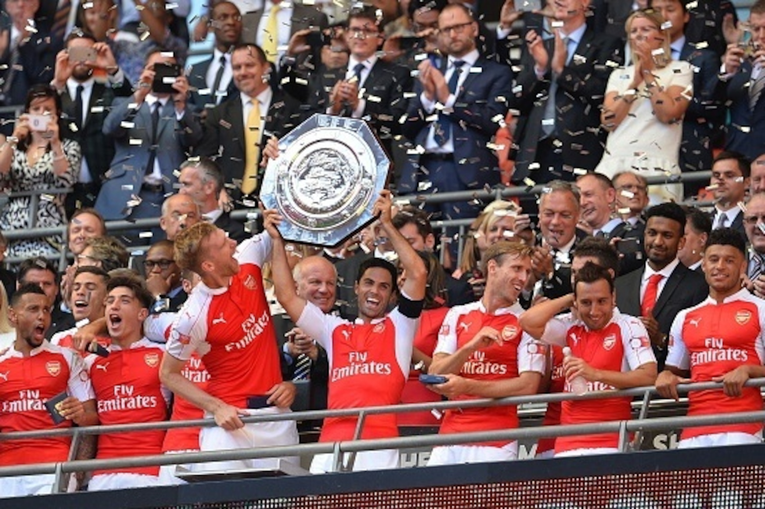 Arsenal's Spanish midfielder Mikel Arteta (C) lifts the trophy as Arsenal players celebrate after beating Chelsea in the FA Community Shield football match between Arsenal and Chelsea at Wembley Stadium in north London on August 2, 2015. Arsenal won the g