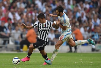 MARSEILLE, FRANCE - AUGUST 01:  Stephane Sparagna (R) of Olympique de Marseille competes with Paulo Dybala of Juventus FC during the preseason friendly match between Olympique de Marseille and Juventus FC at Stade Velodrome on August 1, 2015 in Marseille,