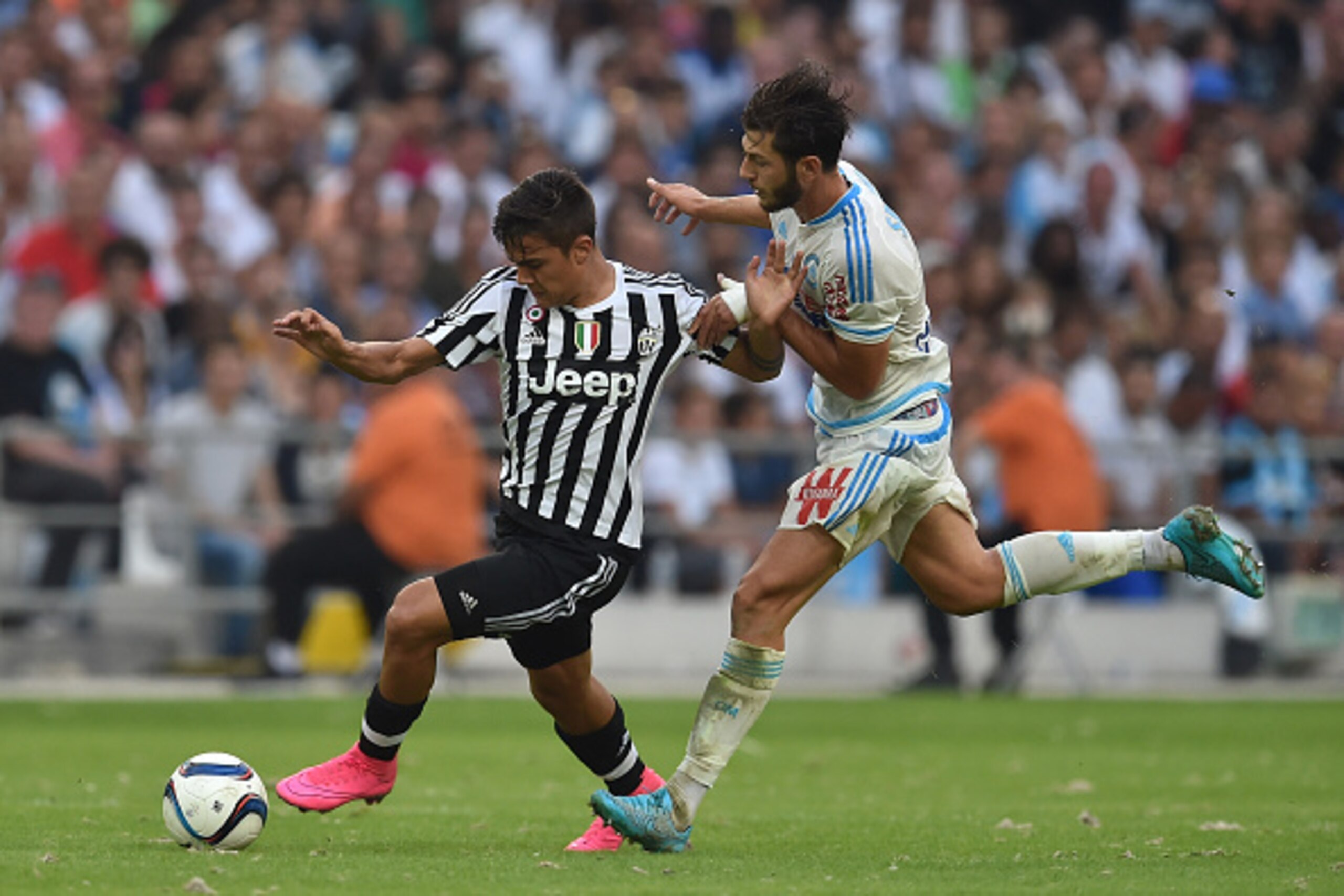 MARSEILLE, FRANCE - AUGUST 01:  Stephane Sparagna (R) of Olympique de Marseille competes with Paulo Dybala of Juventus FC during the preseason friendly match between Olympique de Marseille and Juventus FC at Stade Velodrome on August 1, 2015 in Marseille,