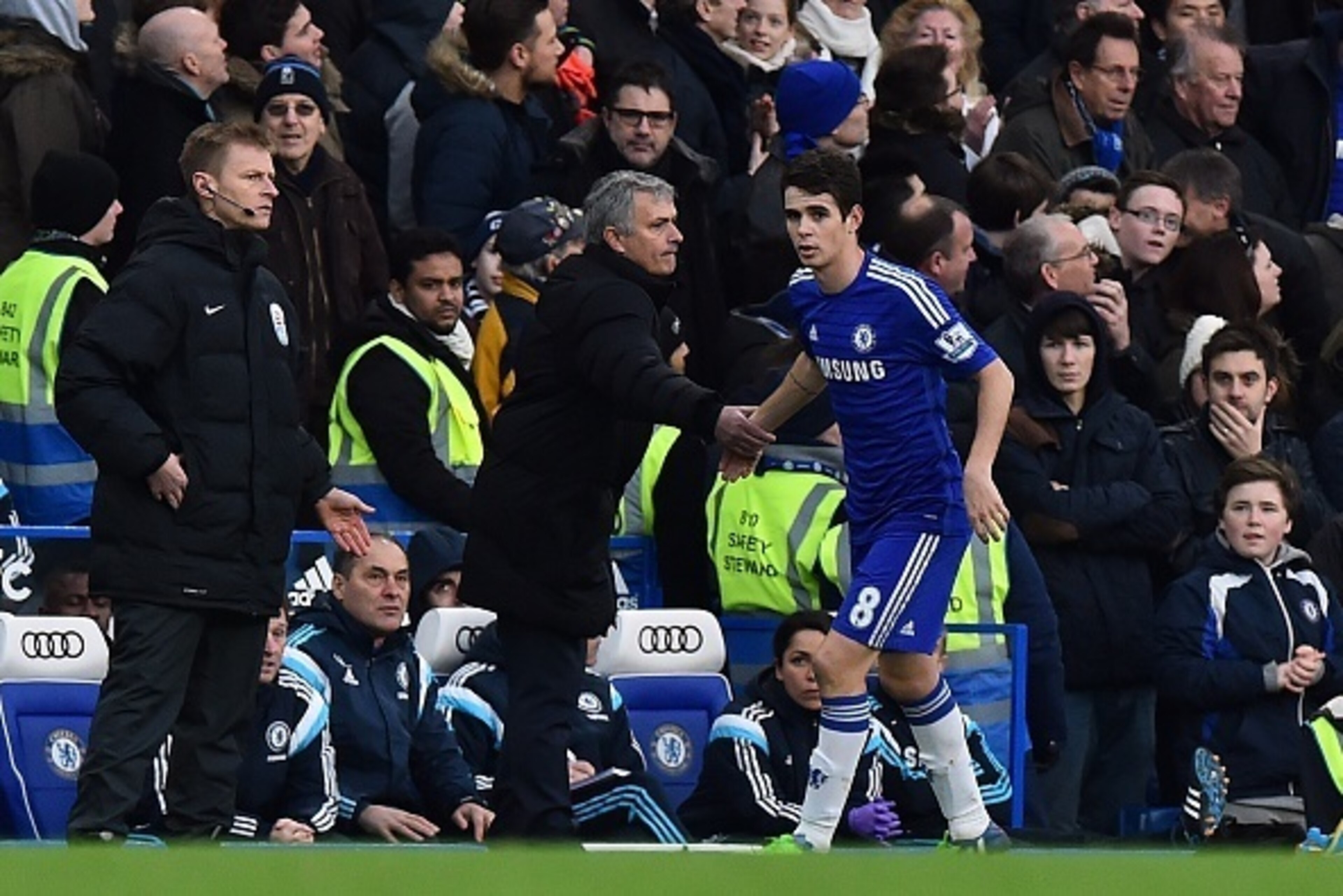 Chelsea's Brazilian midfielder Oscar (R) celebrates scoring the opening goal with Chelsea's Portuguese manager Jose Mourinho (2L) during the English Premier League football match between Chelsea and Newcastle United at Stamford Bridge in London on January