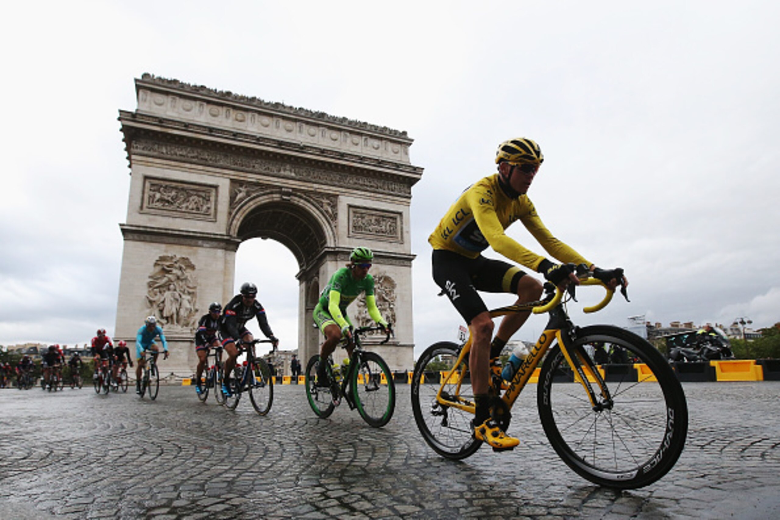 PARIS, FRANCE - JULY 26:  Chris Froome (yellow jersey) of Great Britain and Team Sky rides past the Arc de Triomphe on his way to overall victory during the twenty first stage of the 2015 Tour de France, a 109.5 km stage between Sevres and Paris Champs-El