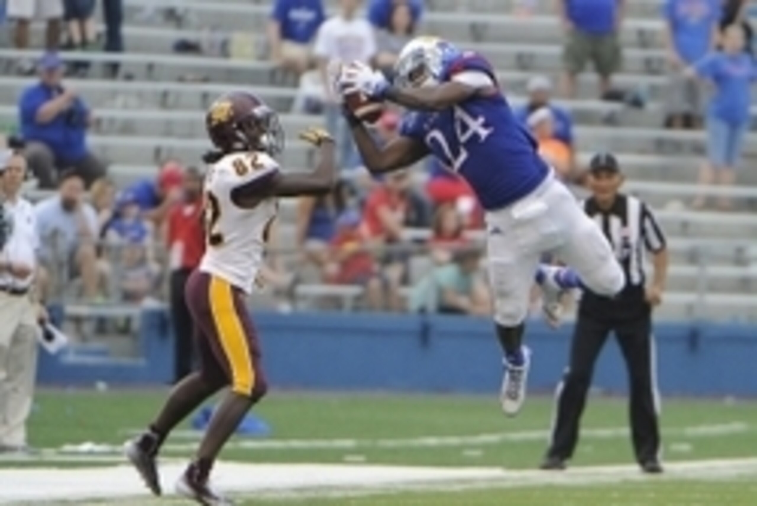 Sep 20, 2014; Lawrence, KS, USA; Kansas Jayhawks cornerback JaCorey Shepherd (24) intercepts a pass intended for Central Michigan Chippewas wide receiver Corey Willis (82) in the second half at Memorial Stadium. Kansas won the game 24-10. Mandatory Credit