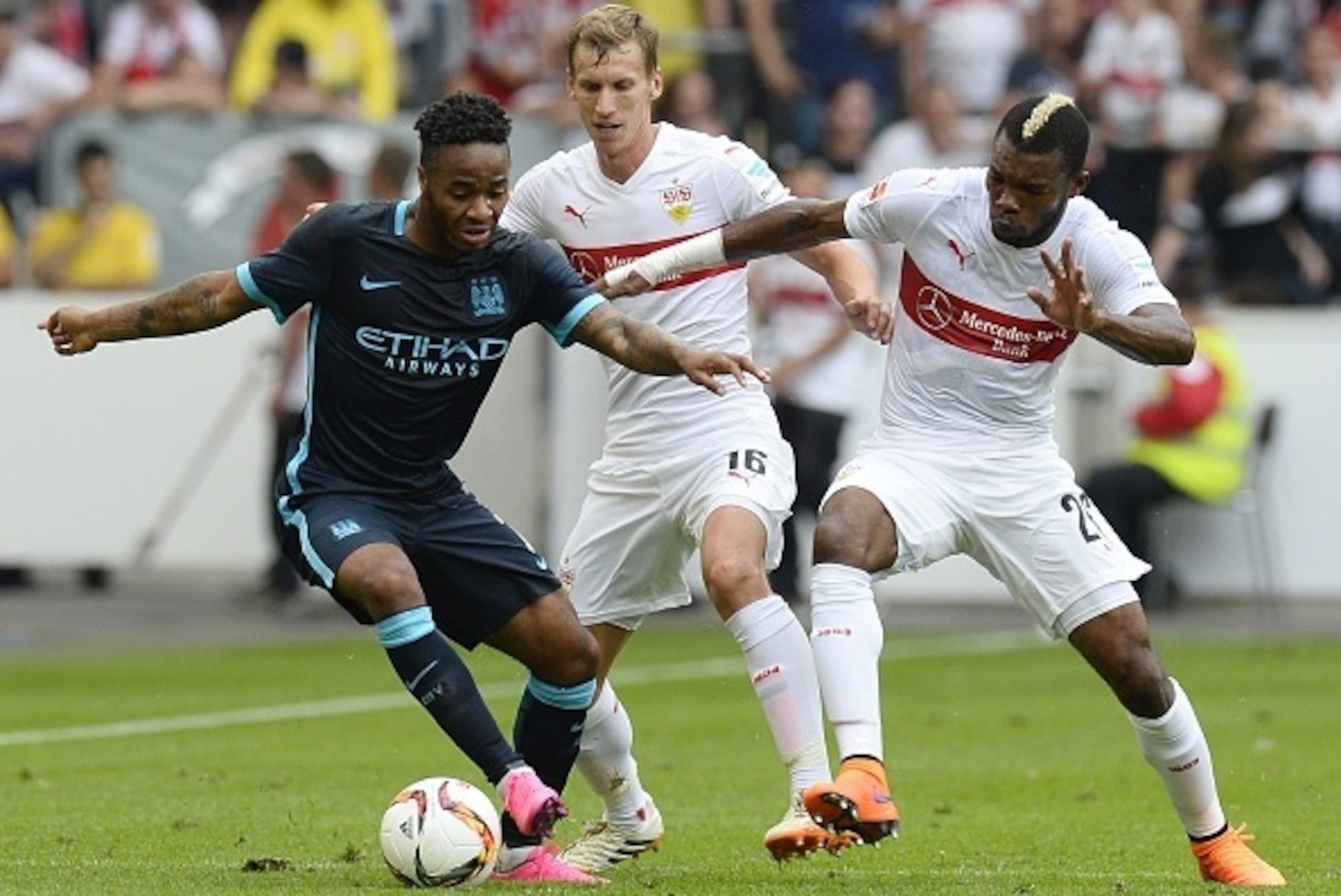 Stuttgart's Ivorian midfielder Serey Die (R) and Austrian defender Florian Klein vie for the ball with Manchester's midfielder Raheem Sterling during the friendly football match between VfB Stuttgart and Manchester City in Stuttgart, southern Germany, on 