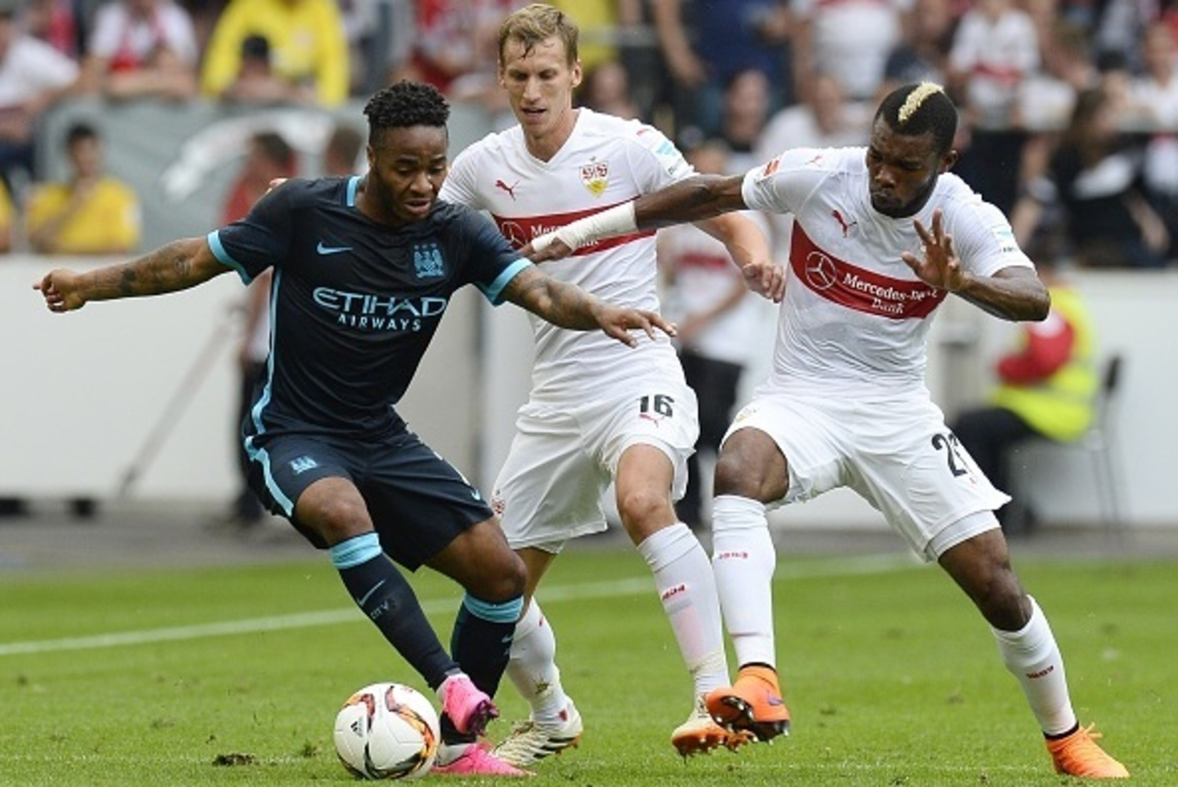 Stuttgart's Ivorian midfielder Serey Die (R) and Austrian defender Florian Klein vie for the ball with Manchester's midfielder Raheem Sterling during the friendly football match between VfB Stuttgart and Manchester City in Stuttgart, southern Germany, on 
