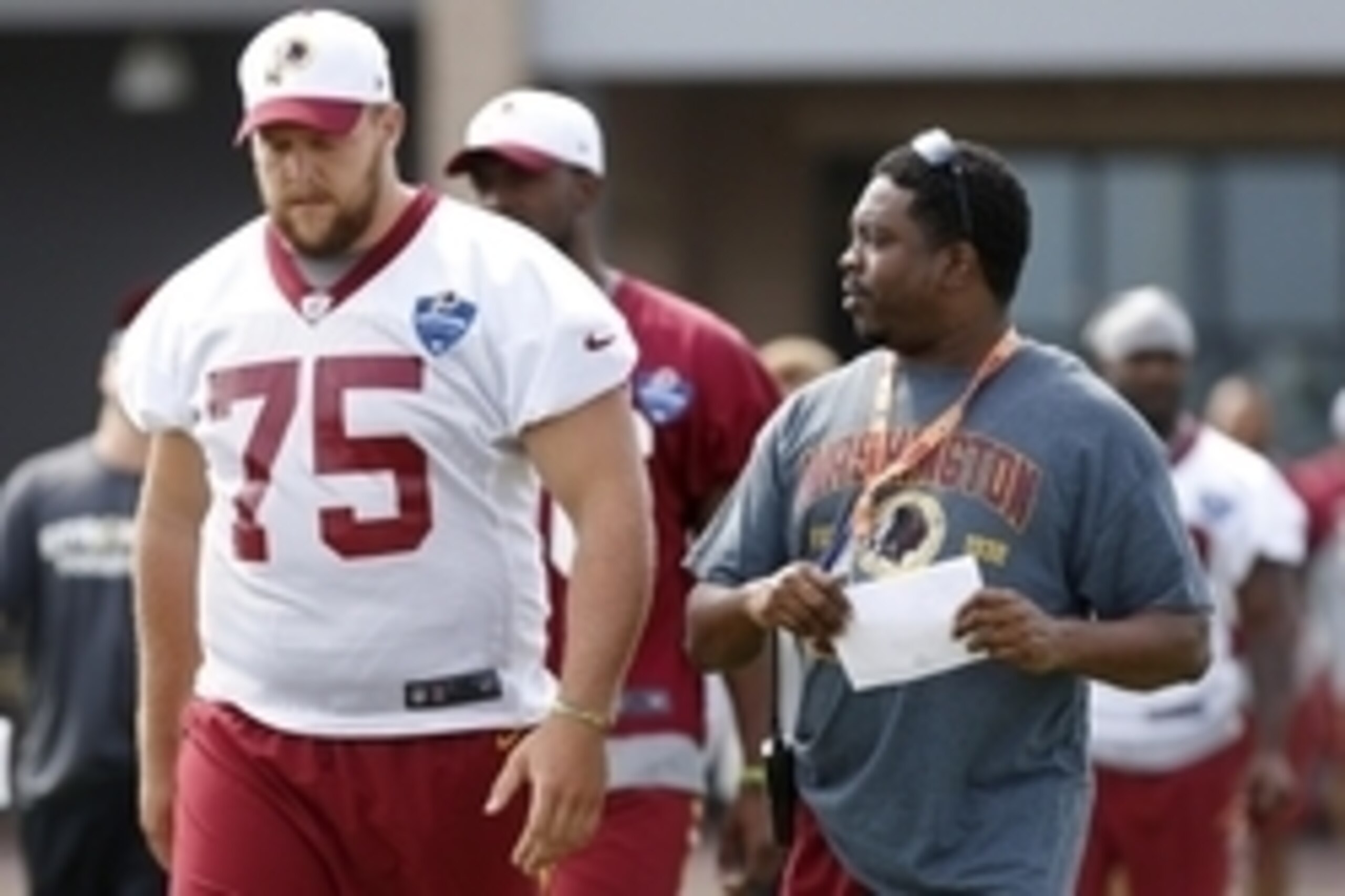 Jul 30, 2015; Richmond, VA, USA; Washington Redskins offensive tackle Brandon Scherff (75) walks onto the field with a member of the Redskins' public relations staff prior to the morning walkthrough on day one of training camp at the Washington Redskins B