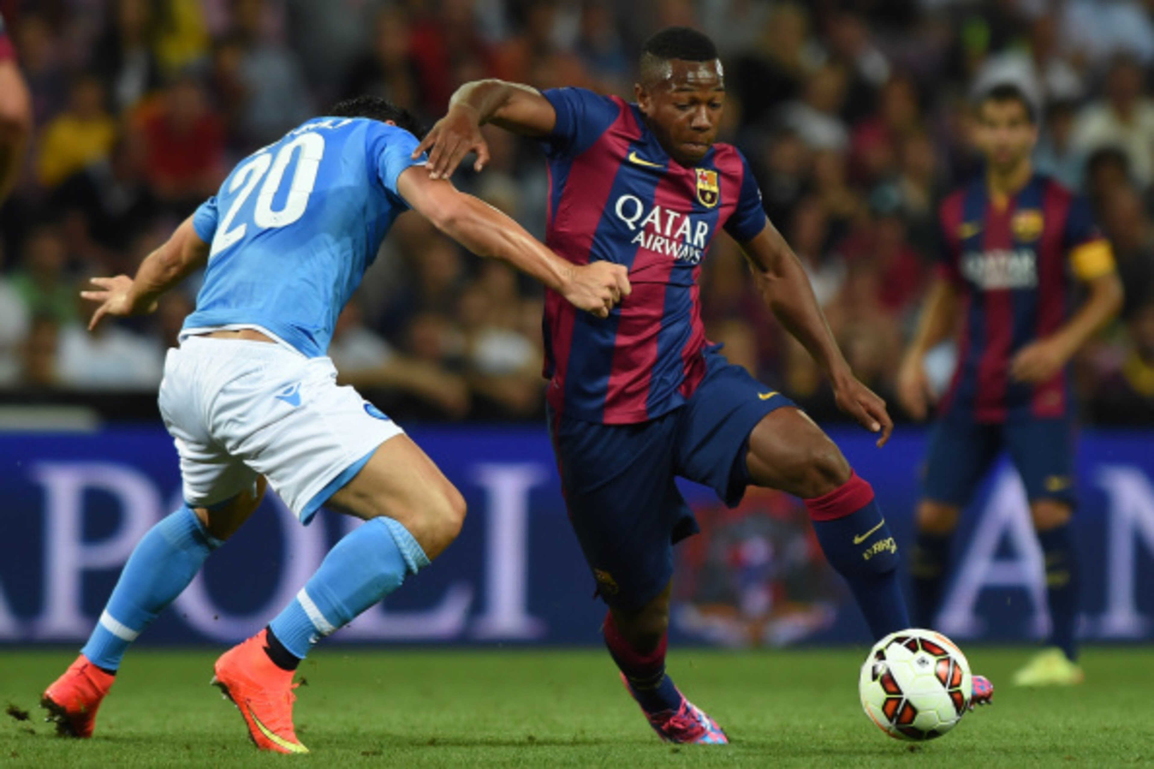 GENEVA, SWITZERLAND - AUGUST 06:  Adama Traore (R) of FC Barcelona is challenged by Blerim Dzemaili of SSC Napoli during the pre-season friendly match between FC Barcelona and SSC Napoli on August 6, 2014 in Geneva, Switzerland.  (Photo by Valerio Pennici