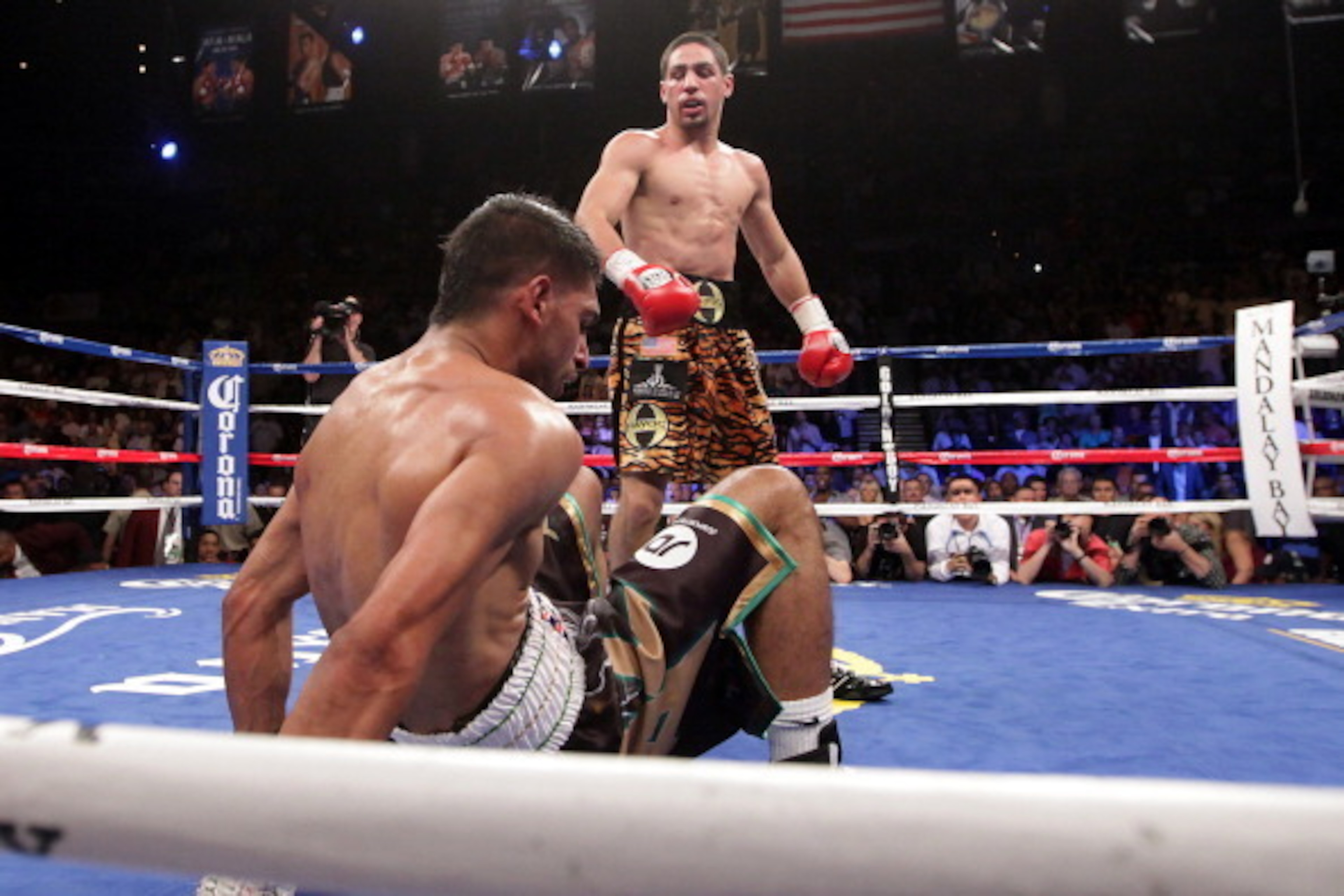 Danny Garcia (top) from Philadelphia, Pennsylvania, stands over Amir Khan, from Bolton, England after knocking him to the canvas in the third round on July 14, 2012 at the Mandalay Bay Events Center in Las Vegas, Nevada. Garcia defeated Khan with a TKO i Danny Garcia (top) from Philadelphia, Pennsylvania, stands over Amir Khan, from Bolton, England after knocking him to the canvas in the third round on July 14, 2012 at the Mandalay Bay Events Center in Las Vegas, Nevada. Garcia defeated Khan with a TKO i