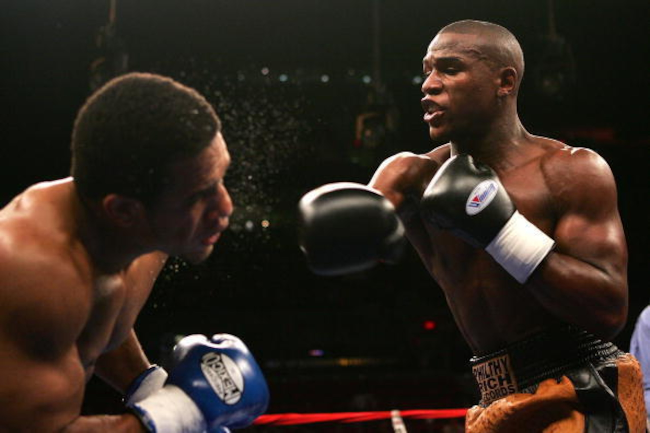 PORTLAND, OR - NOVEMBER 19:  Floyd Mayweather (R) hits Sharmba Mitchell during their welterweight fight at the Rose Garden on November 19, 2005 in Portland, Oregon. Mayweather defeated Mitchell in a sixth round TKO.  (Photo by Jed Jacobsohn/Getty Images)