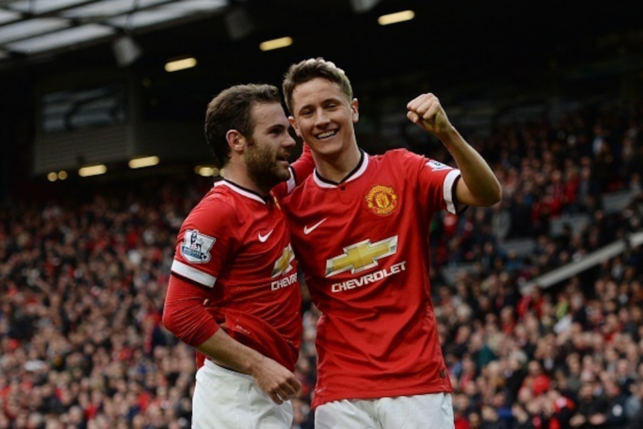 Manchester United's Spanish midfielder Ander Herrera (R) celebrates scoring their third goal with Manchester United's Spanish midfielder Juan Mata (L) during the English Premier League football match between Manchester United and Aston Villa at Old Traffo