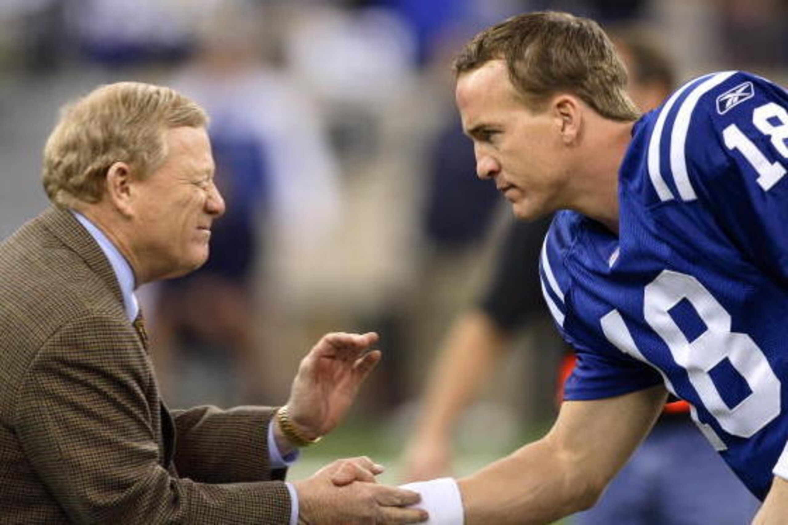 INDIANAPOLIS - JANUARY 21: Peyton Manning #18 of the Indianapolis Colts is greeted by Bill Polian the team's president before the AFC Championship game against the New England Patriots at the RCA Dome on January 21, 2007 in Indianapolis, Indiana. The Col INDIANAPOLIS - JANUARY 21: Peyton Manning #18 of the Indianapolis Colts is greeted by Bill Polian the team's president before the AFC Championship game against the New England Patriots at the RCA Dome on January 21, 2007 in Indianapolis, Indiana. The Col