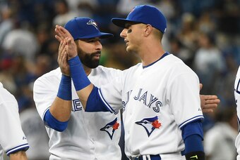 Jul 29, 2015; Toronto, Ontario, CAN;  Toronto Blue Jays shortstop Troy Tulowitzki (right) gets a hand slap and a backpat from designated hitter Jose Bautista (left) as they celebrate an 8-2 win over Philadelphia Phillies at Rogers Centre. Mandatory Credit