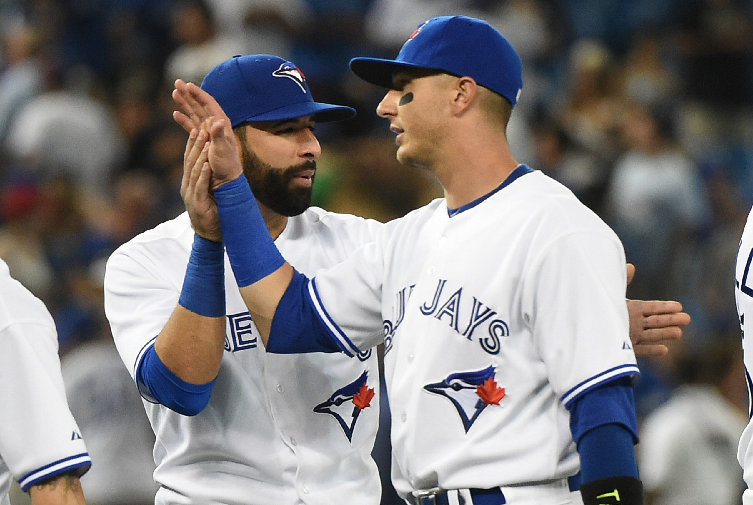 Jul 29, 2015; Toronto, Ontario, CAN;  Toronto Blue Jays shortstop Troy Tulowitzki (right) gets a hand slap and a backpat from designated hitter Jose Bautista (left) as they celebrate an 8-2 win over Philadelphia Phillies at Rogers Centre. Mandatory Credit