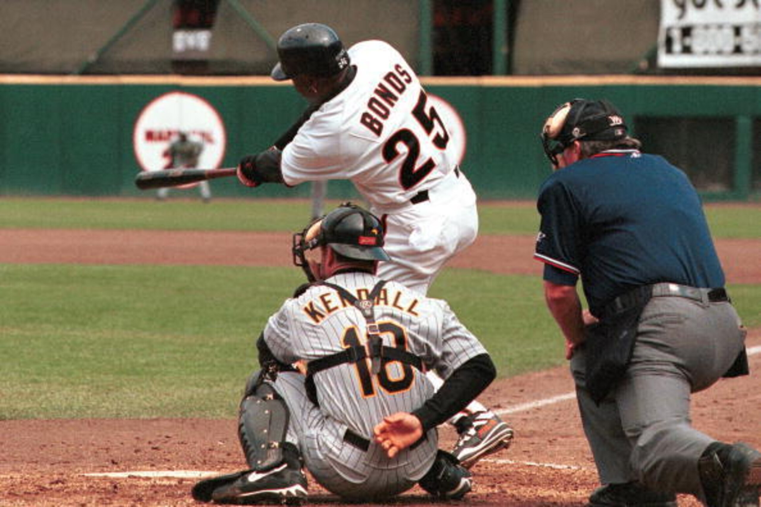 SAN FRANCISCO, UNITED STATES:  San Francisco Giants slugger Barry Bonds follows through with a stand up double as Pittsburgh Pirates catcher Jason Kendall and homeplate umpire Dana DeMuth watch as the Giants defeated the Pirates, 6-2, in San Francisco, CA