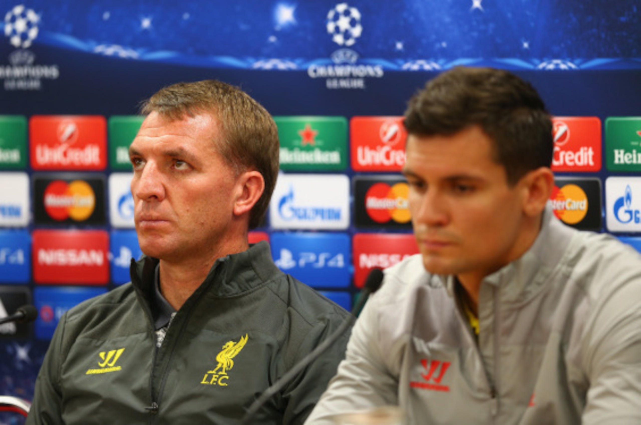 LIVERPOOL, ENGLAND - SEPTEMBER 15:  Liverpool manager Brendan Rodgers deep in thought as he talks to the media whilst sitting next to his defender Dejan Lovren during a press conference ahead of their UEFA Champions League group B match against PFC Ludogo