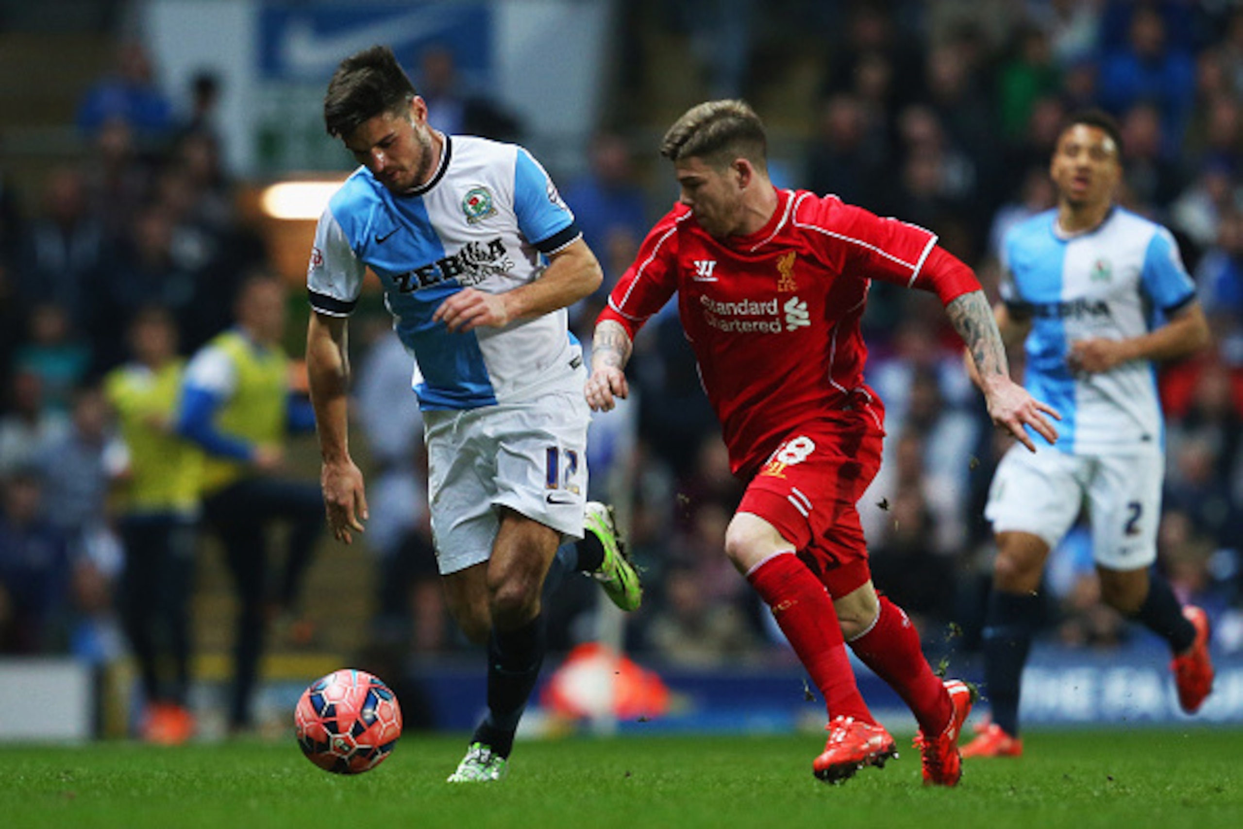 BLACKBURN, ENGLAND - APRIL 08:  Ben Marshall of Blackburn Rovers and Alberto Moreno of Liverpool battle for the ball during the FA Cup Quarter Final Replay match between Blackburn Rovers and Liverpool at Ewood Park on April 8, 2015 in Blackburn, England. 