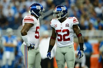 Sep 8, 2014; Detroit, MI, USA; New York Giants inside linebacker Jameel McClain (53) talks with outside linebacker Jon Beason (52) against the Detroit Lions at Ford Field. Mandatory Credit: Andrew Weber-USA TODAY Sports