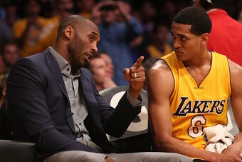 LOS ANGELES, CA - MARCH 10:  Kobe Bryant #24 of the Los Angeles Lakers talks on the bench with Jordan Clarkson #6 during the game with the Detroit Pistons at Staples Center on March 10, 2015 in Los Angeles, California.     NOTE TO USER: User expressly ack