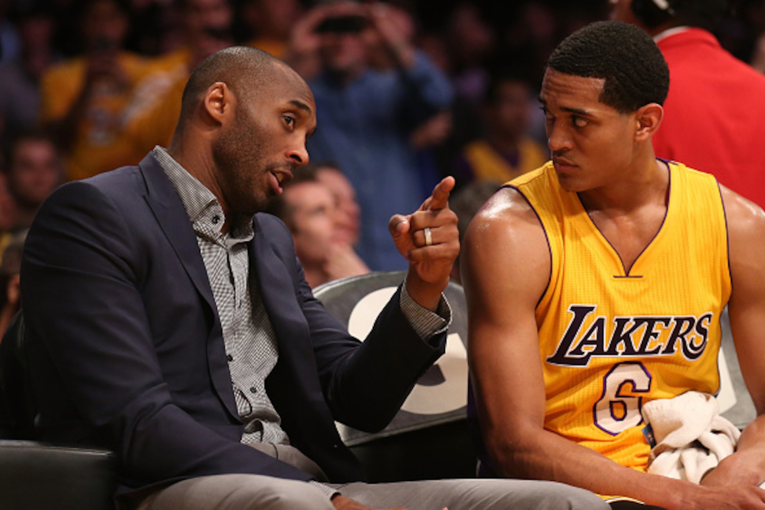 LOS ANGELES, CA - MARCH 10:  Kobe Bryant #24 of the Los Angeles Lakers talks on the bench with Jordan Clarkson #6 during the game with the Detroit Pistons at Staples Center on March 10, 2015 in Los Angeles, California.     NOTE TO USER: User expressly ack