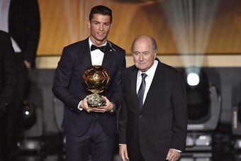 Real Madrid and Portugal forward Cristiano Ronaldo (L) poses holding his 2014 FIFA Ballon d'Or award for player of the year with FIFA president Sepp Blatter (C) during the FIFA Ballon d'Or award ceremony at the Kongresshaus in Zurich on January 12, 2015. 