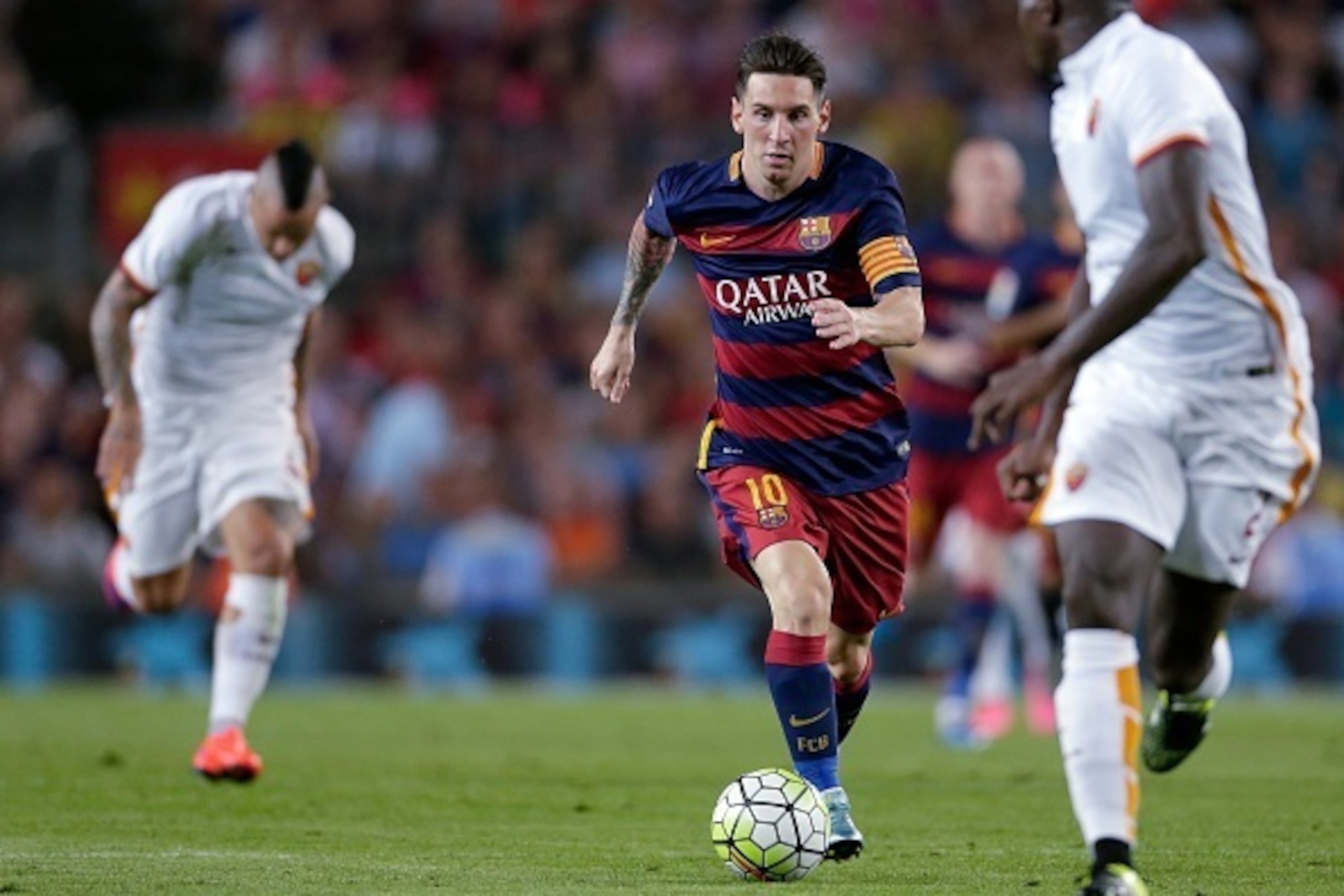 (L-R) Lionel Messi of FC Barcelona, Y Mapou of AS Roma during the Joan Gamper Trophy match between Barcelona and AS Roma on August 5, 2015 at the Camp Nou stadium in Barcelona, Spain.(Photo by VI Images via Getty Images)