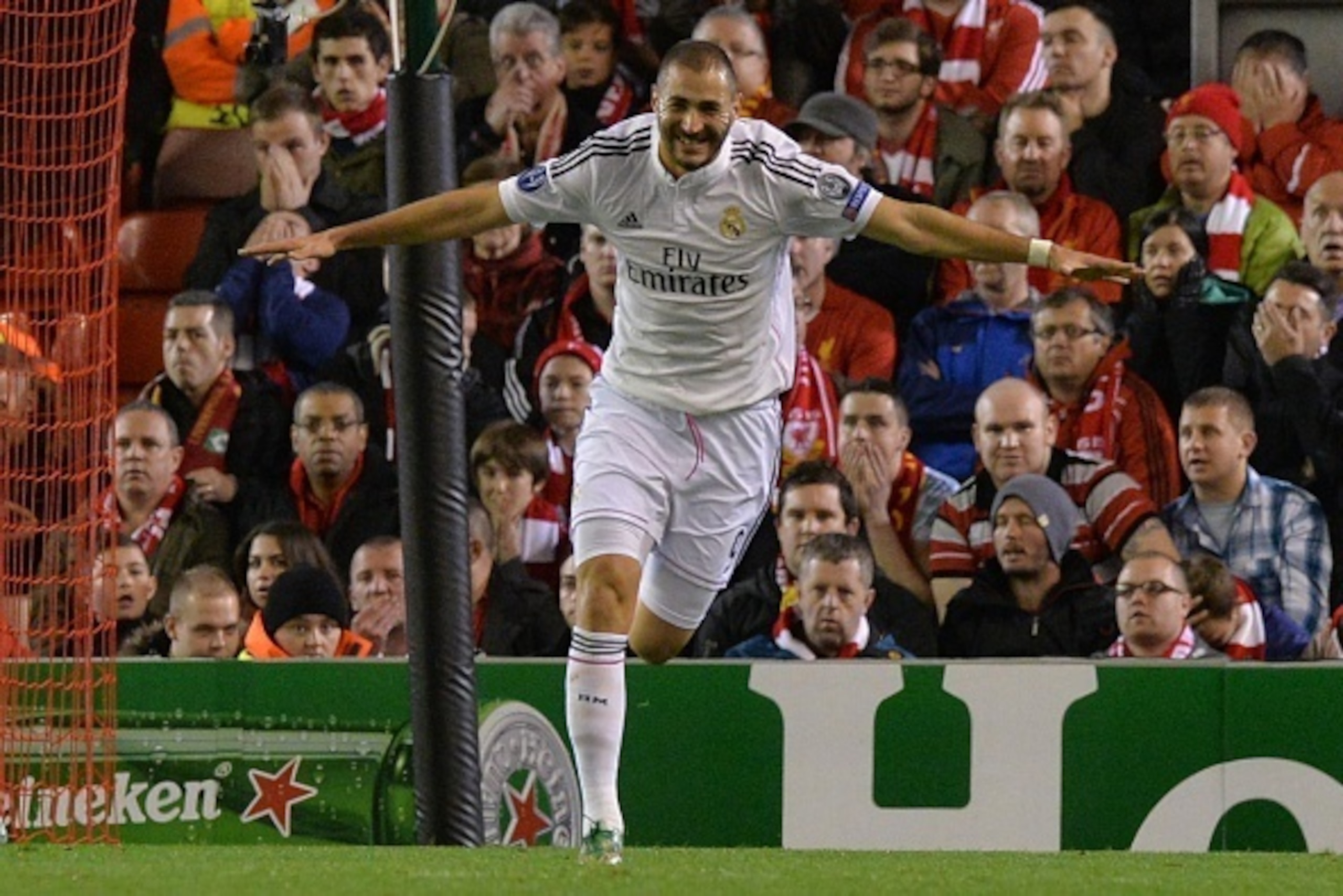 Real Madrid's French forward Karim Benzema celebrates scoring Real Madrid's second goal during the UEFA Champions League, group B, football match between Liverpool and Real Madrid at Anfield in Liverpool, northwest England, on October 22, 2014. AFP PHOTO 