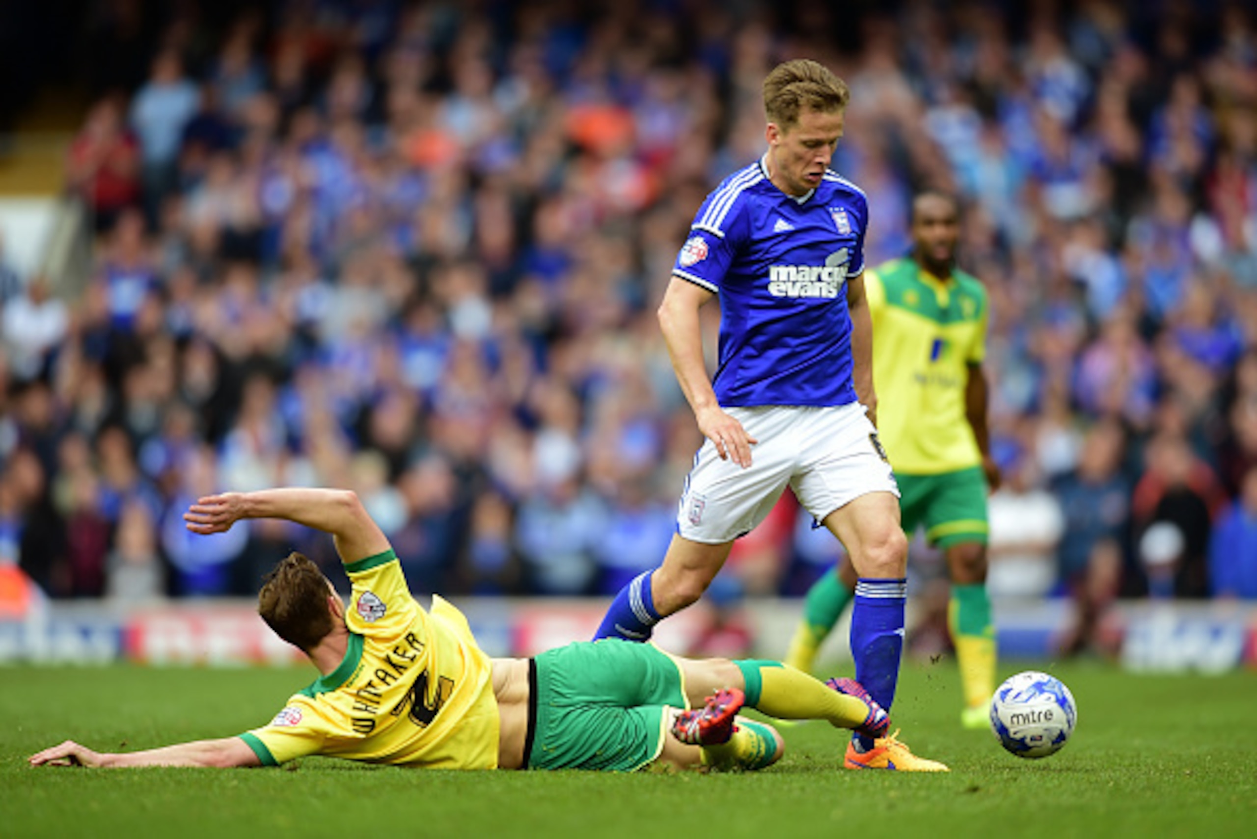 IPSWICH, ENGLAND - MAY 09: Christophe Berra of Ipswich is tackled by Steven Whittaker of Norwich during the Sky Bet Championship Playoff semi-final first leg match between Ipswich Town and Norwich Cityat Portman Road on May 9, 2015 in Ipswich, England.  (