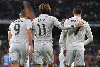 MADRID, SPAIN - MARCH 15:  Gareth Bale of Real Madrid celebrates with Cristiano Ronaldo and Karim Benzema  after scoring Real's opening goal during the La Liga match between Real Madrid CF and Levante UD at Estadio Santiago Bernabeu on March 15, 2015 in M