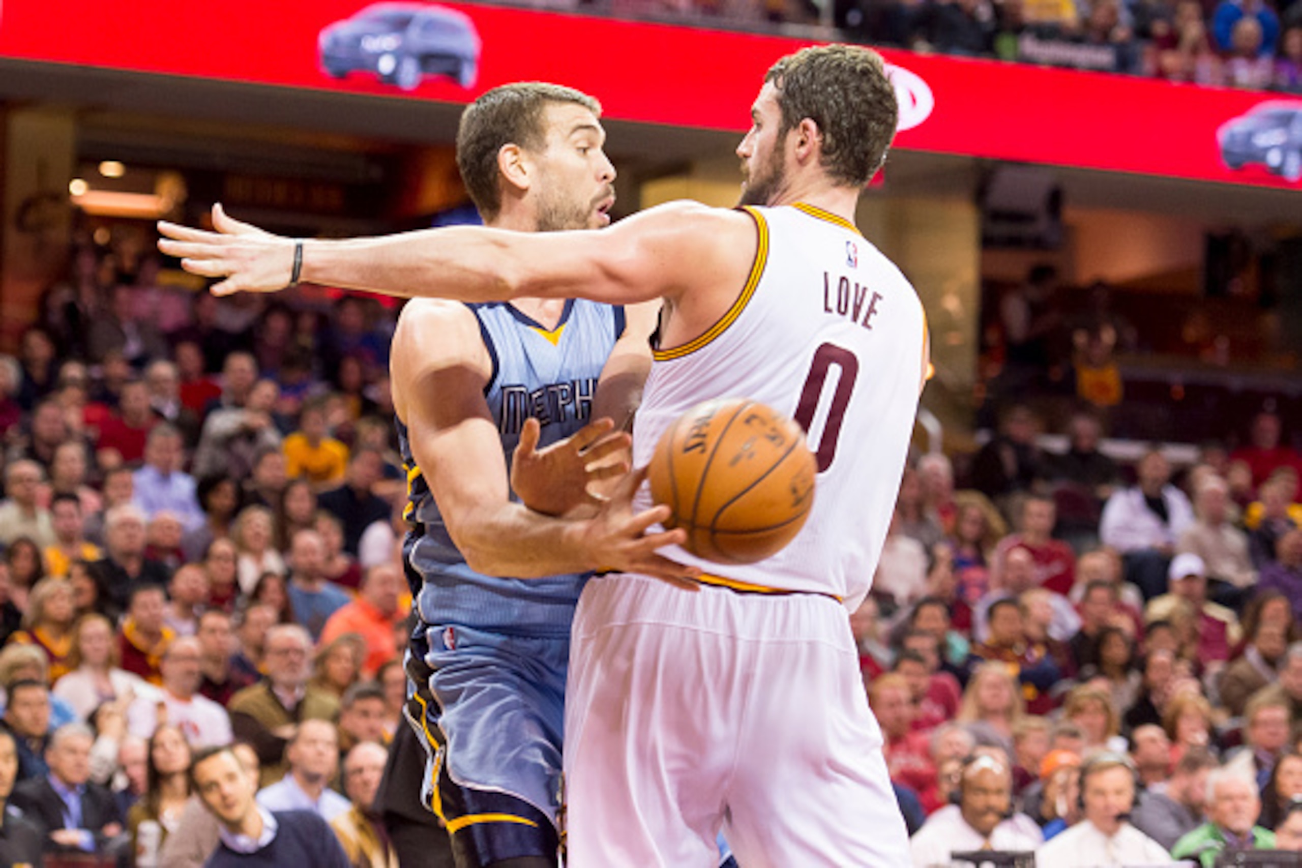 CLEVELAND, OH - DECEMBER 21: Marc Gasol #33 of the Memphis Grizzlies passes around Kevin Love #0 of the Cleveland Cavaliers during the first half at Quicken Loans Arena on December 21, 2014 in Cleveland, Ohio. NOTE TO USER: User expressly acknowledges and