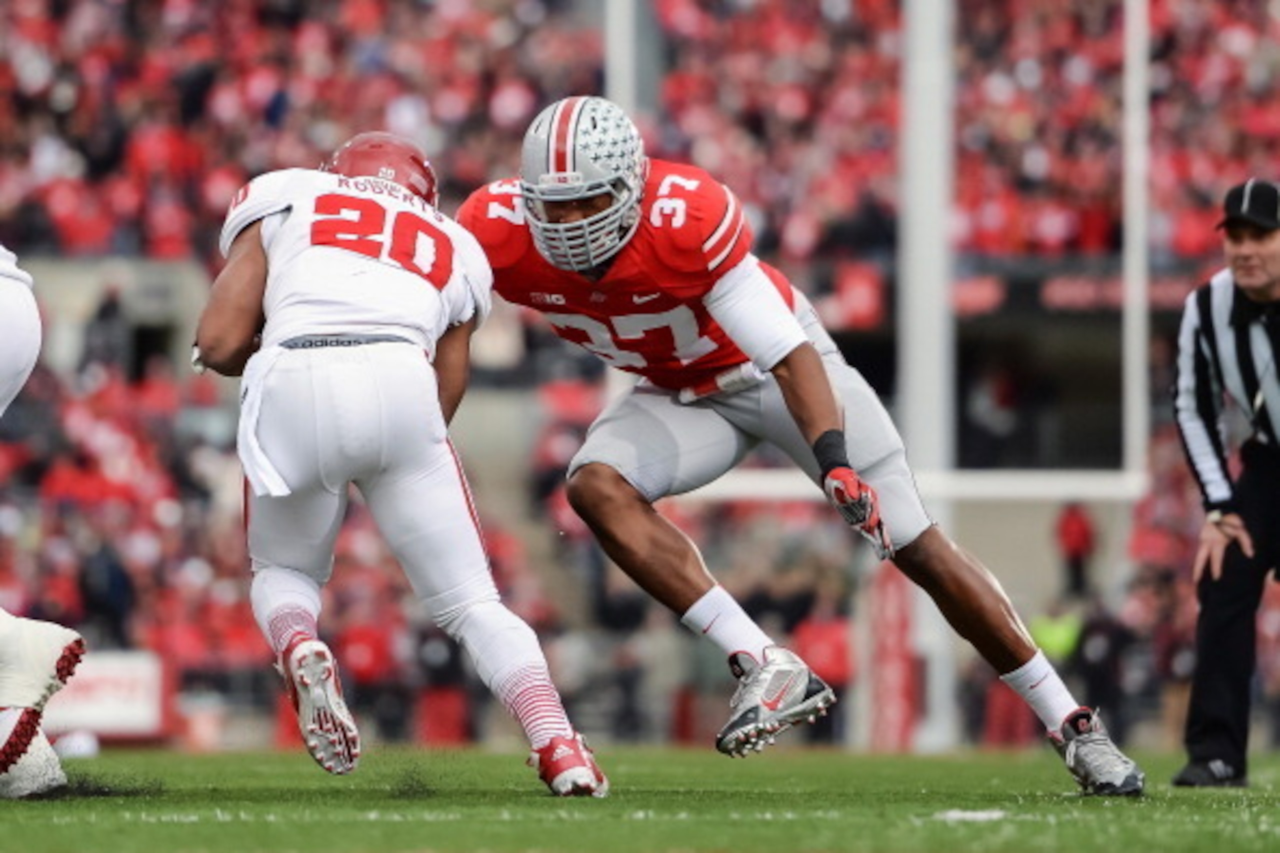 COLUMBUS, OH - NOVEMBER 23:  Joshua Perry #37 of the Ohio State Buckeyes tackles D'Angelo Roberts #20 of the Indiana Hoosiers at Ohio Stadium on November 23, 2013 in Columbus, Ohio.  (Photo by Jamie Sabau/Getty Images)
