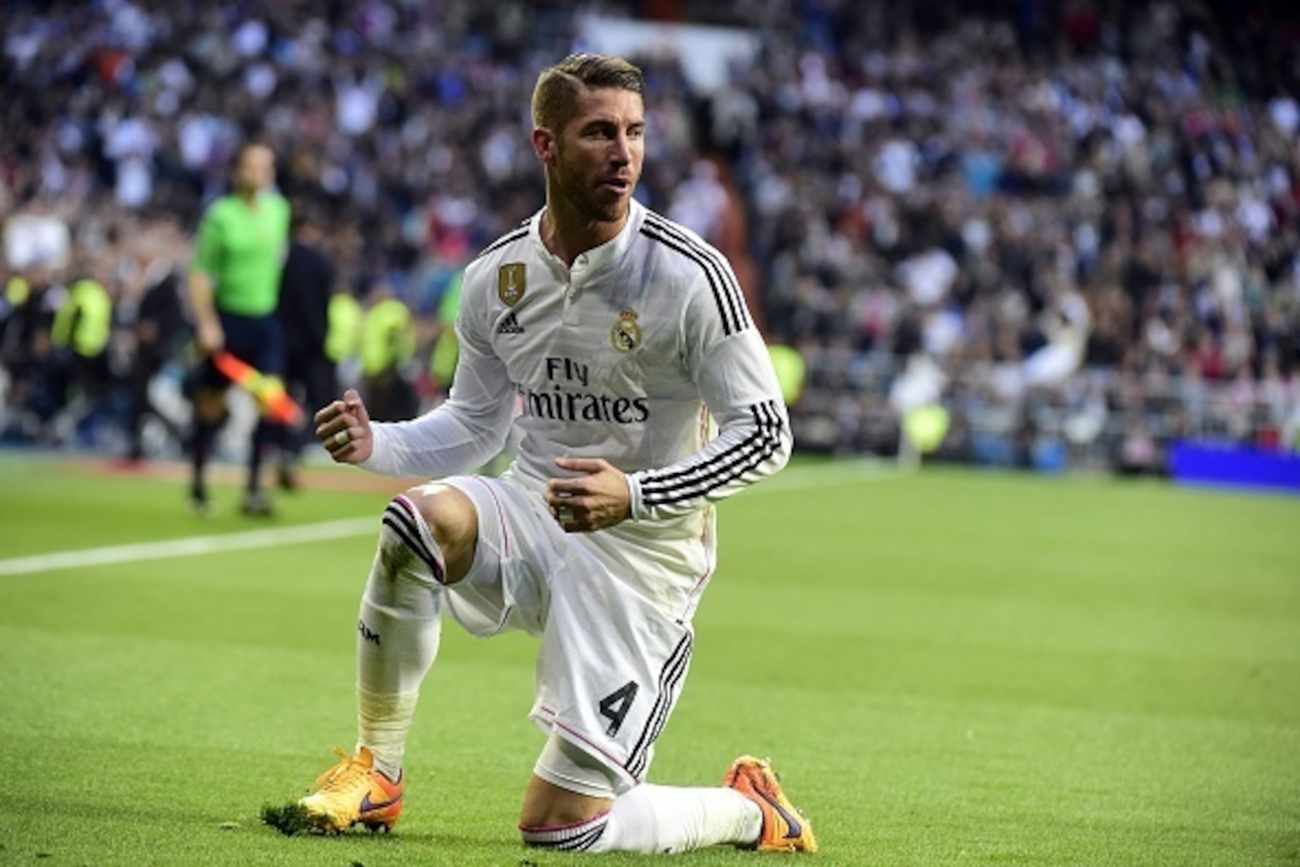 Real Madrid's defender Sergio Ramos celebrates after scoring during the Spanish league football match Real Madrid CF vs Malaga FC at the Santiago Bernabeu stadium in Madrid on April 18, 2015.   AFP PHOTO/ GERARD JULIEN        (Photo credit should read GER