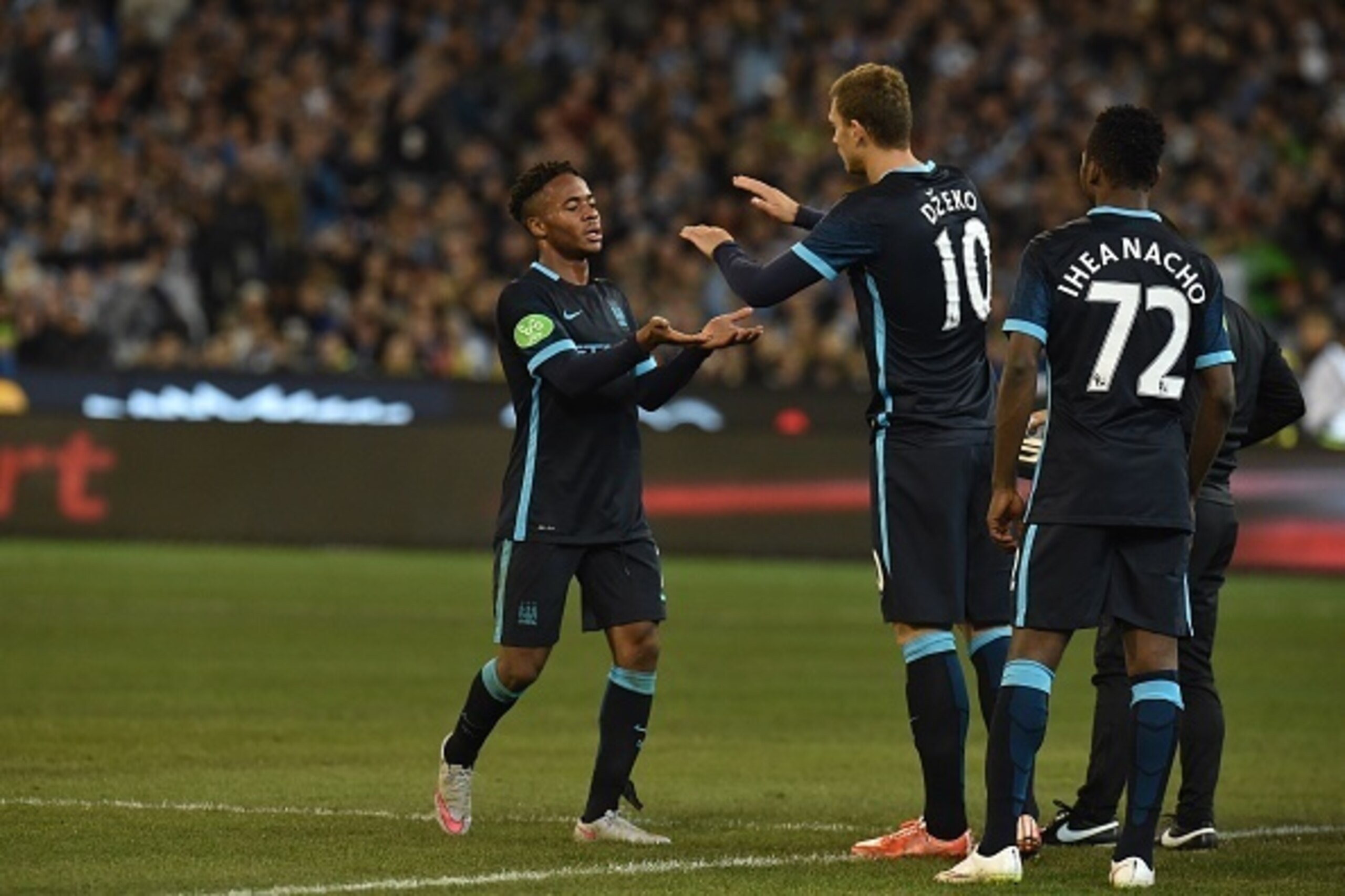 Manchester City midfielder Raheem Sterling (L) subs off with Edin Dzeko (R) during the International Champions Cup Australia football match between English Premier League team Manchester City and Spanish side Real Madrid in Melbourne on July 24, 2015. AFP