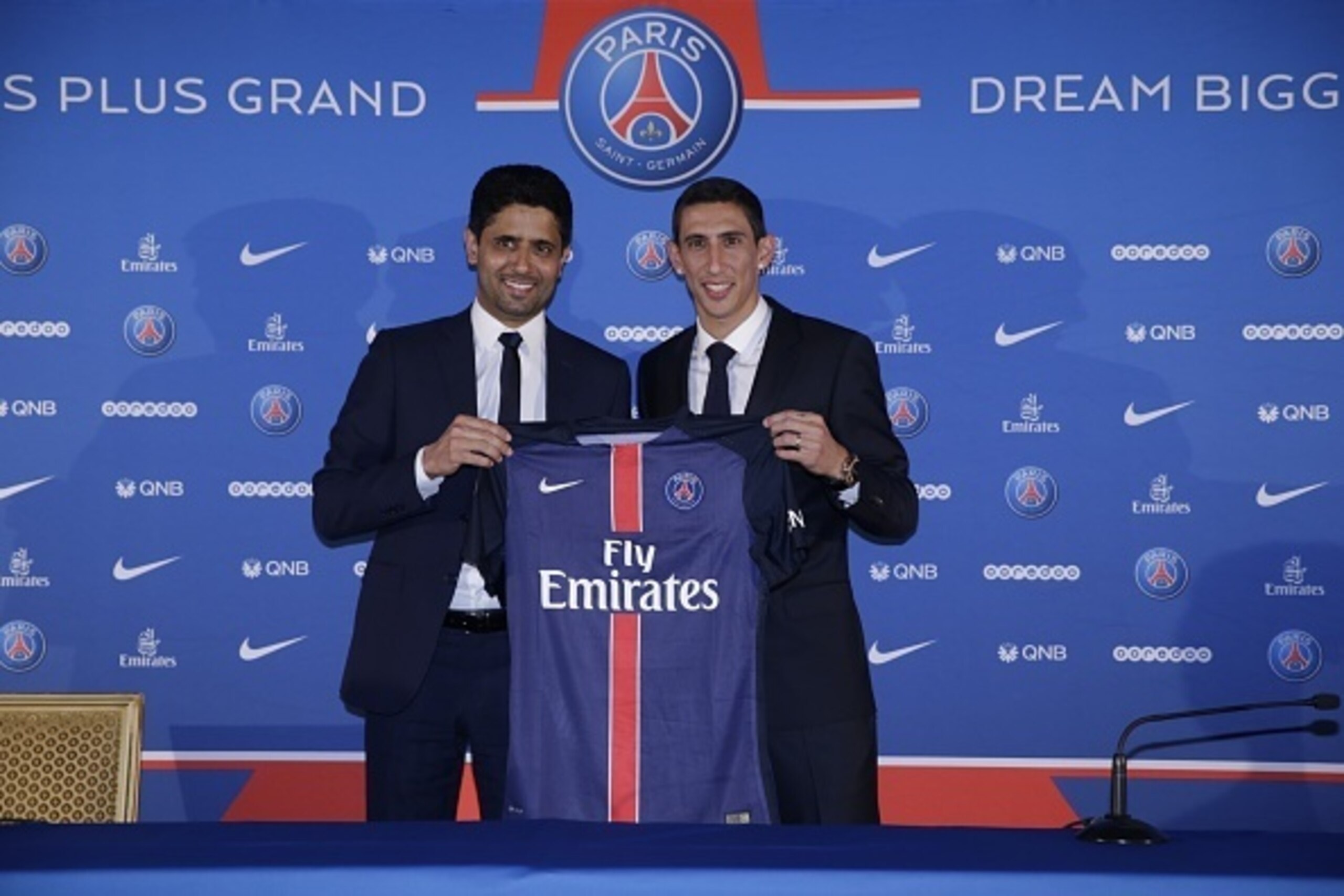 Paris Saint-Germain's (PSG) new Argentinian midfielder Angel Di Maria (R) and Paris Saint-Germain's Qatari president Nasser Al-Khelaifi pose with Di Maria's PSG jersey during his official presentation in Paris on August 6, 2015. Paris Saint-Germain comple
