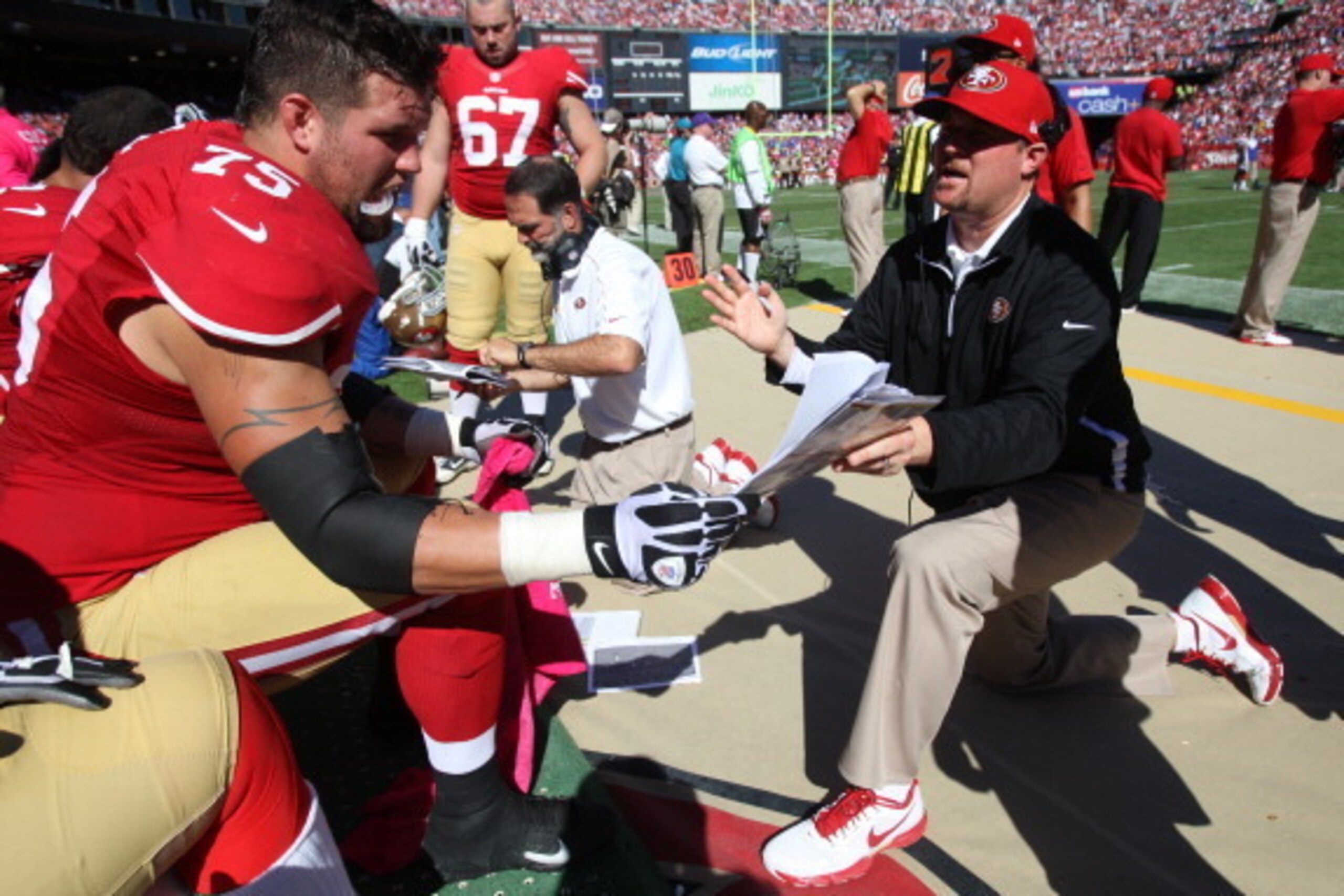SAN FRANCISCO, CA - OCTOBER 14: Offensive Line Coach Tim Drevno of the San Francisco 49ers talks with Alex Boone #75 during the game against the New York Giants at Candlestick Park on October 14, 2012 in San Francisco, California. The Giants defeated the 